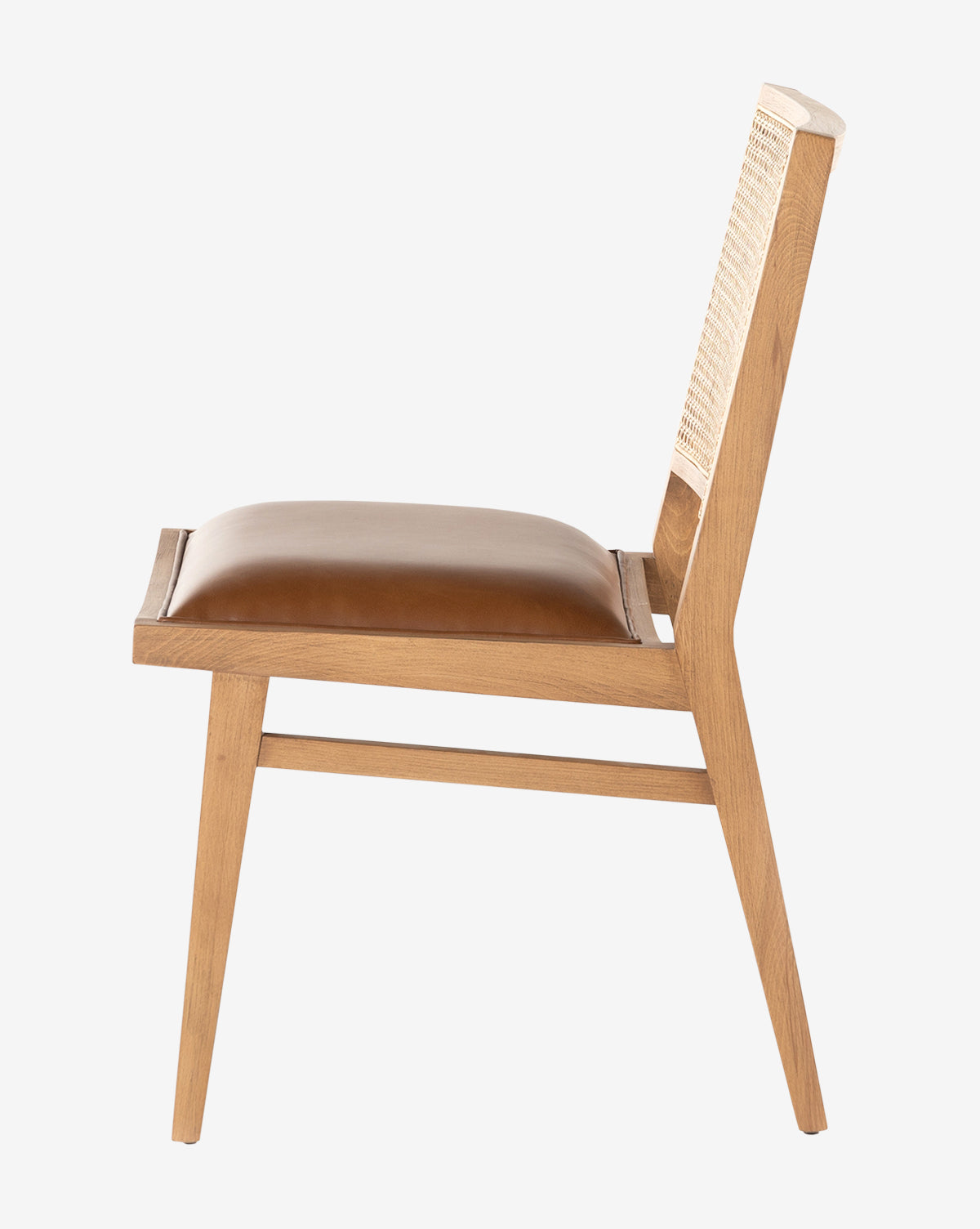Side view of the Jett Dining Chair, featuring a beech wood frame, woven backrest, and brown padded leather seat, displayed on a plain white background by McGee & Co.
