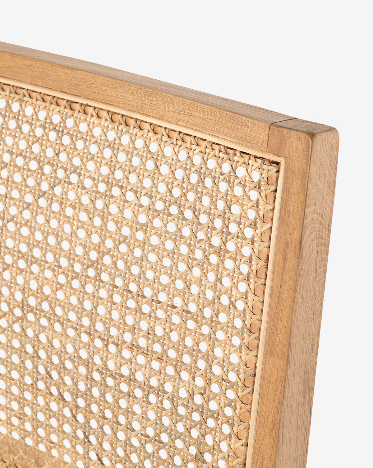 Close-up of the Jett Dining Chair’s backrest features a woven cane pattern, showcasing detailed craftsmanship, natural beech wood texture, and a leather seat against a white background, by McGee & Co.