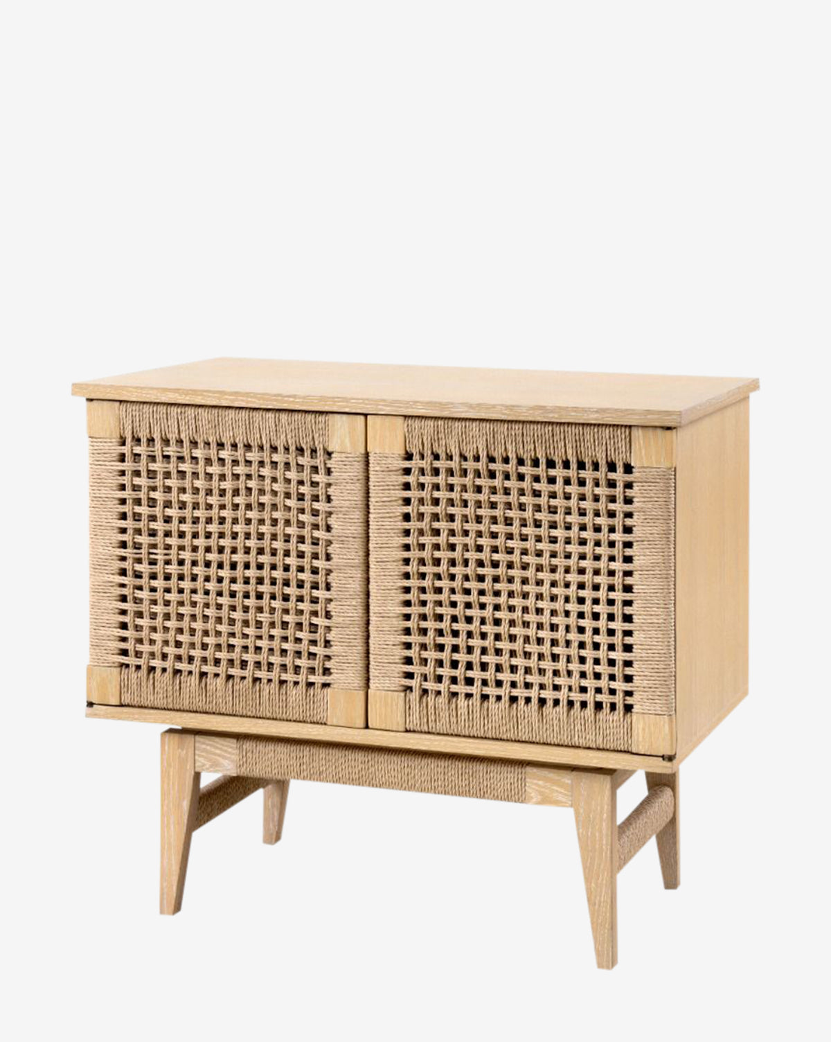 The Jovan Cabinet features a light oak finish with two woven rattan doors and four angled legs, showcasing a minimalist and natural design against a plain white background, by McGee & Co.
