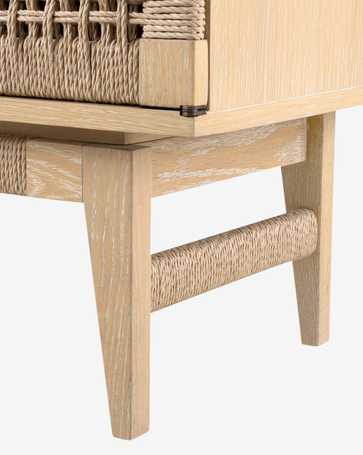 Close-up of the Jovan Cabinet’s oak leg, featuring woven rope details and a textured wooden frame that highlight the craftsmanship in both woodwork and weaving, by McGee & Co.