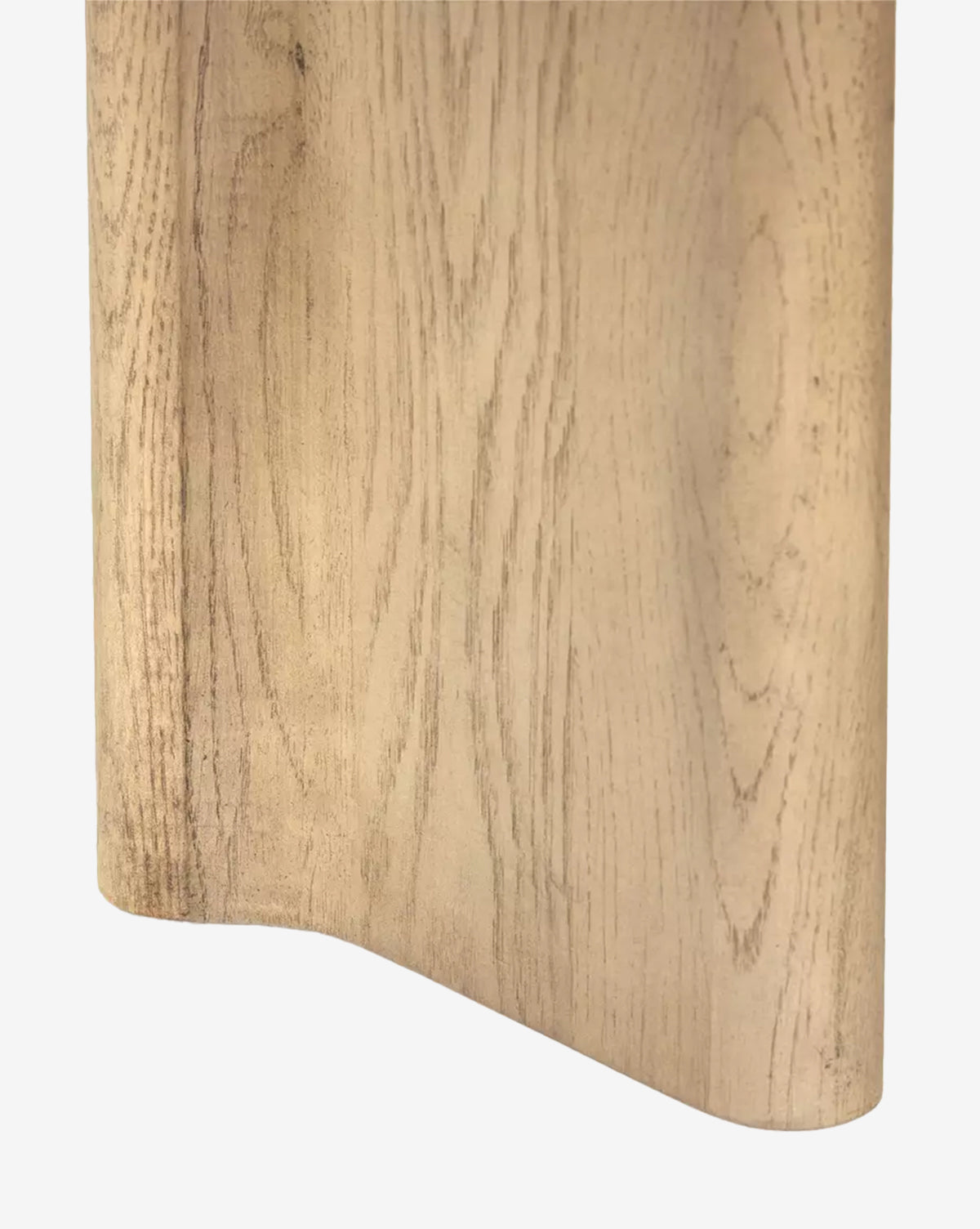 A close-up of the Juliana Extension Dining Table in solid oak highlights its curved edge, smooth texture, and natural wood grain—an ideal addition to any modern dining space, by McGee & Co.