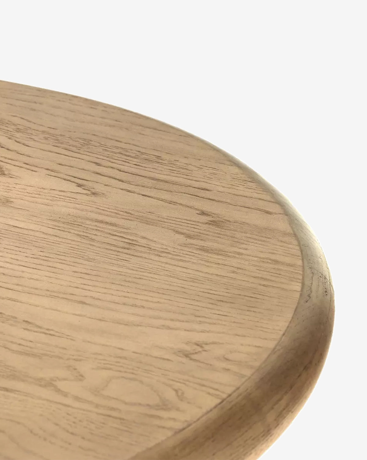 Close-up of the Juliana Extension Dining Table’s solid oak edge, highlighting its smooth, light finish and distinct wood grain patterns, exemplifying modern design against a plain white background, by McGee & Co.