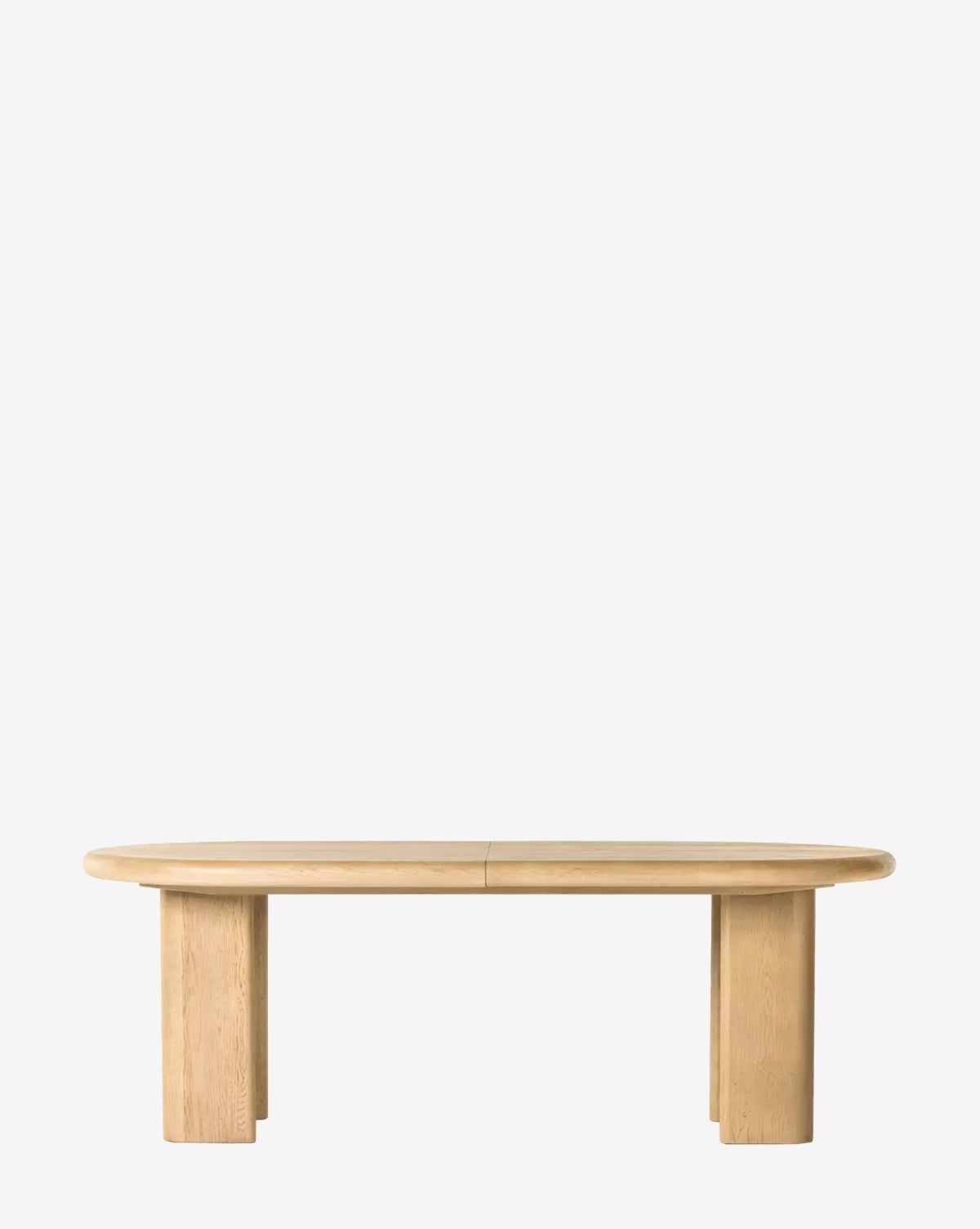 The Juliana Extension Dining Table is a modern solid oak table with an oval top and thick rectangular legs, featuring a sleek tabletop design, shown against a plain white background by McGee & Co.