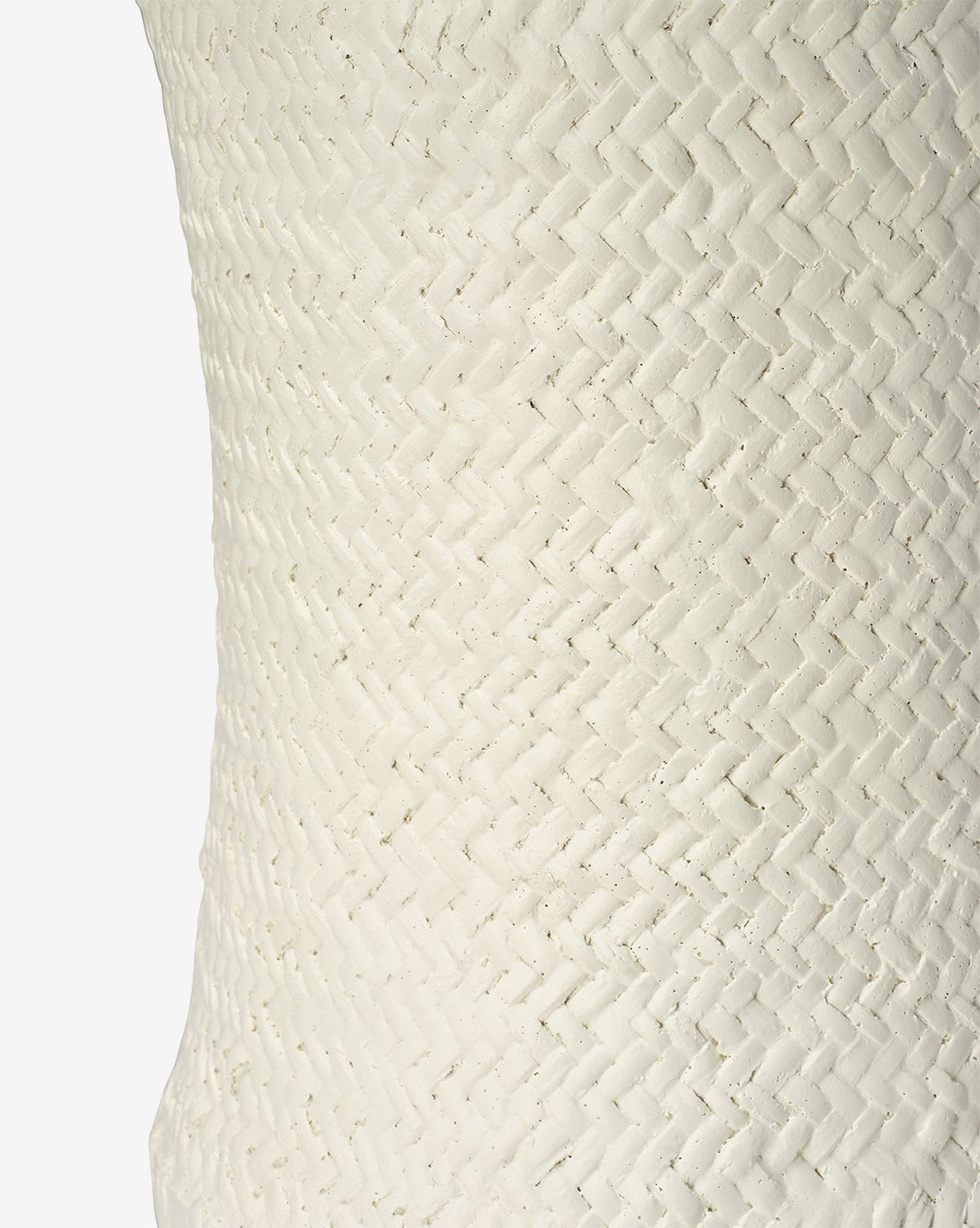 Close-up of the Keira Stool by Made Goods, featuring a textured white surface with a diagonal woven herringbone pattern inspired by basket weaving. The simple background highlights the stool’s tactile and visually striking design. McGee & Co.