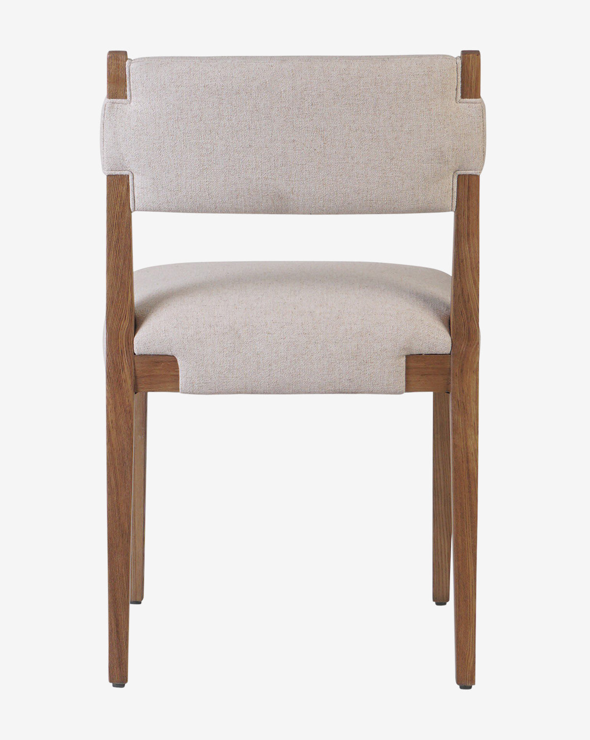 The Kennebec Dining Chair features a light beige performance fabric seat and backrest, seen from the front against a white background. Its ash frame presents clean lines and a minimalist, modern design by McGee & Co.