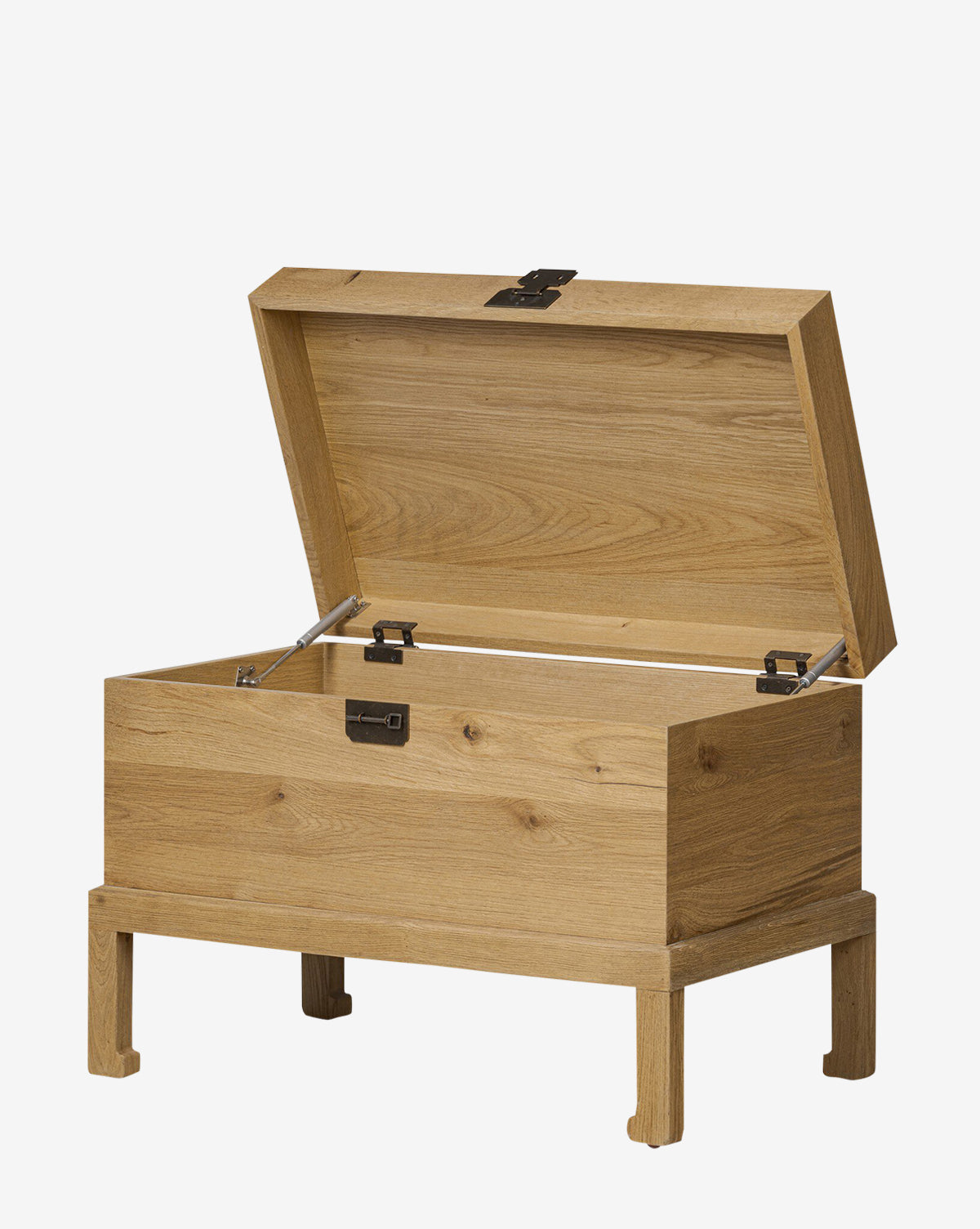 The Kenneth Bench is a wooden chest with a hinged lid that opens to an empty interior. It stands on four sturdy legs, features iron hardware, and displays a natural wood grain finish by McGee & Co.