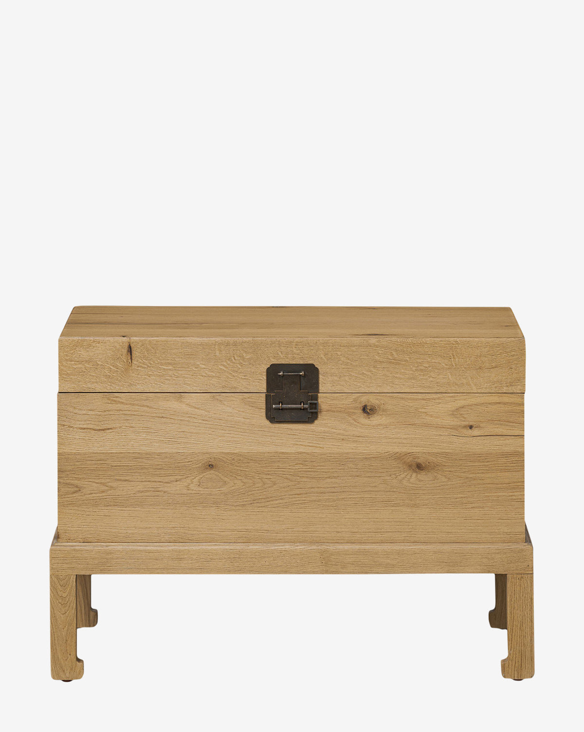 The Kenneth Bench is a rectangular wooden chest with a natural finish, sturdy iron hardware, a front metal latch, and short, slightly elevated legs by McGee & Co.