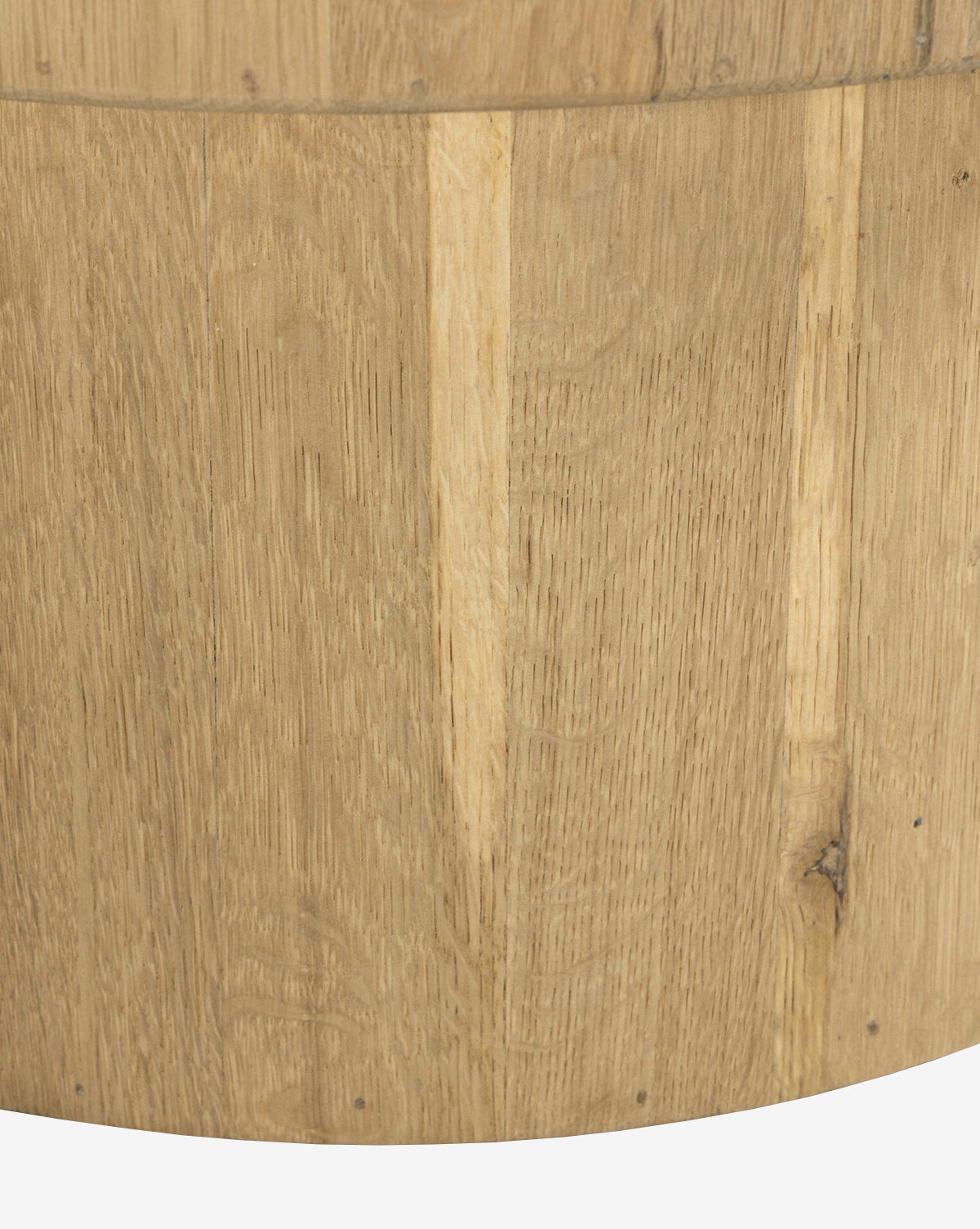 Close-up of the Kinlaw 60 Round Dining Table’s wooden surface, showing vertical grain patterns and natural color variations, with a solid oak base, by McGee & Co.