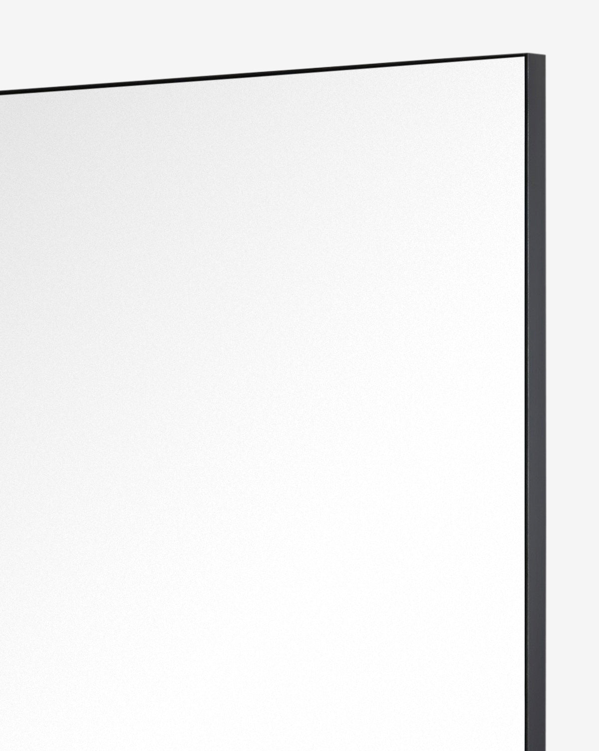 A close-up of the top right corner of the Knowles Mirror, featuring a slim Black Nickel frame against a plain light background, by McGee & Co.