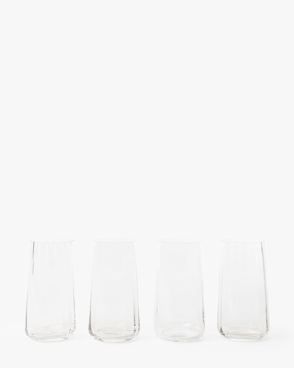 A set of four Langford Highball Glasses is arranged in a row against a plain white background, by McGee & Co.