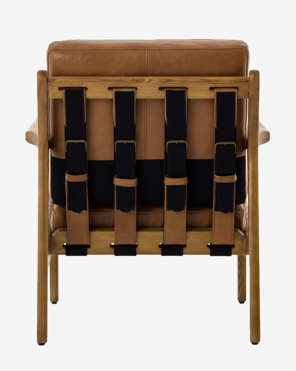 The Lanston Lounge Chair is a brown leather armchair with an ash wood frame, viewed from the back. It features four wide black straps vertically supporting the backrest. The background is plain white, by McGee & Co.