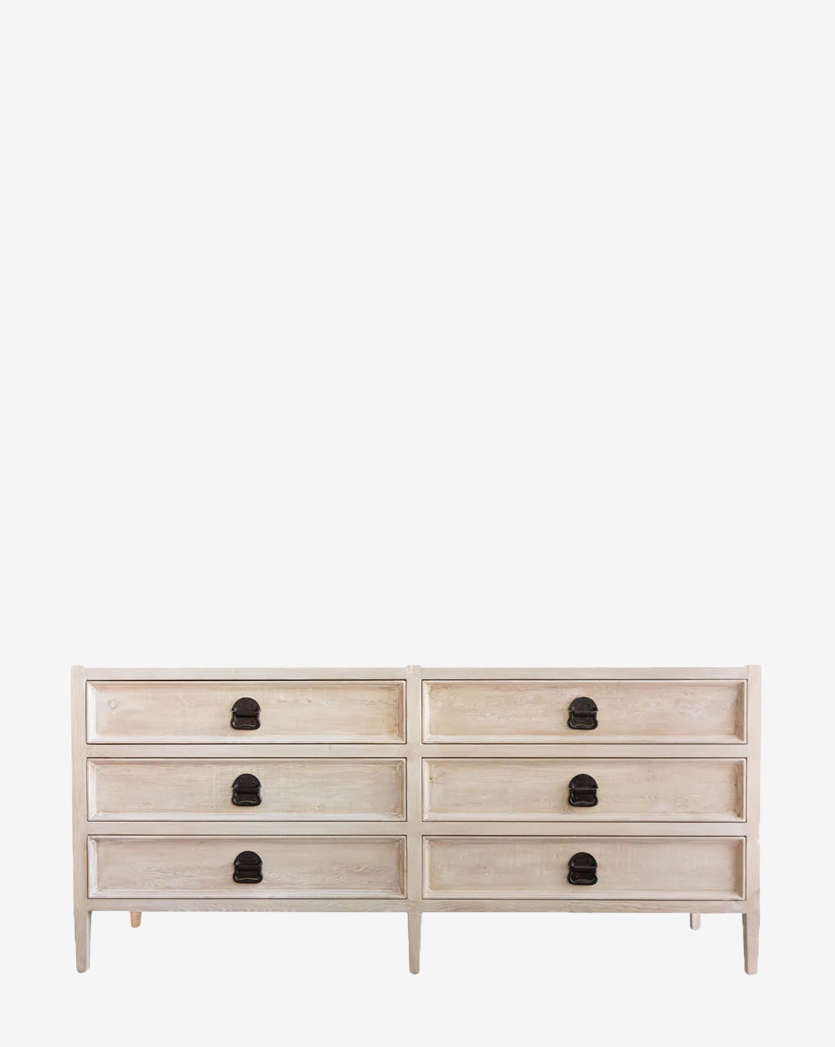 The Lazlo 6-Drawer Dresser features a wooden gray wash finish with a light, distressed look. It offers six drawers in two rows, each with dark round metal pulls, and stands on simple straight legs by McGee & Co.