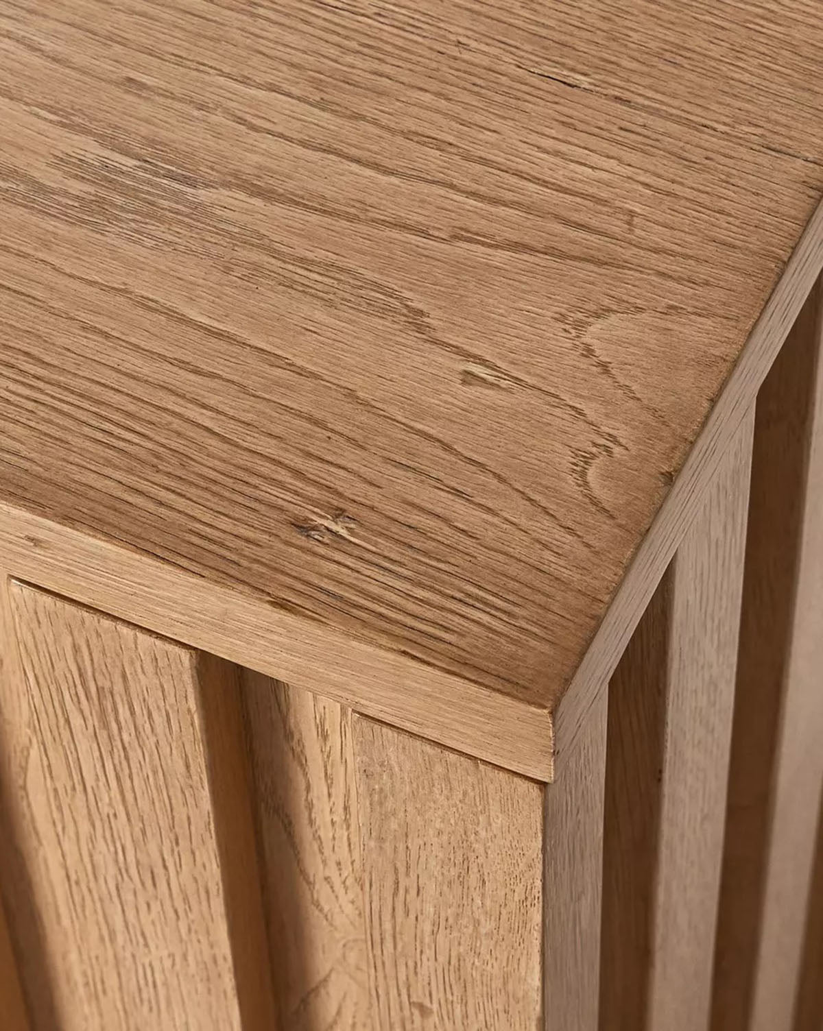 The Leith Console is a square light oak side table featuring vertical front grooves and a minimalist modern design, shown against a plain white background by McGee & Co.