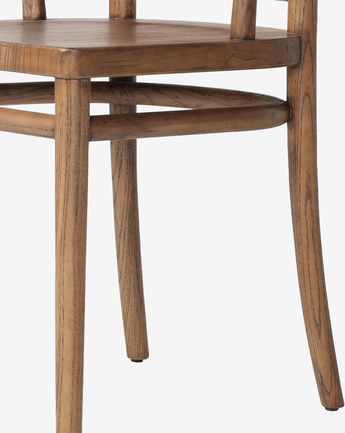Close-up of the Lennon Dining Chair highlighting its natural wood finish, visible grain, and minimalist rustic design. The image shows the seat, two legs, and part of the backrest for a detailed look at its craftsmanship, by McGee & Co.