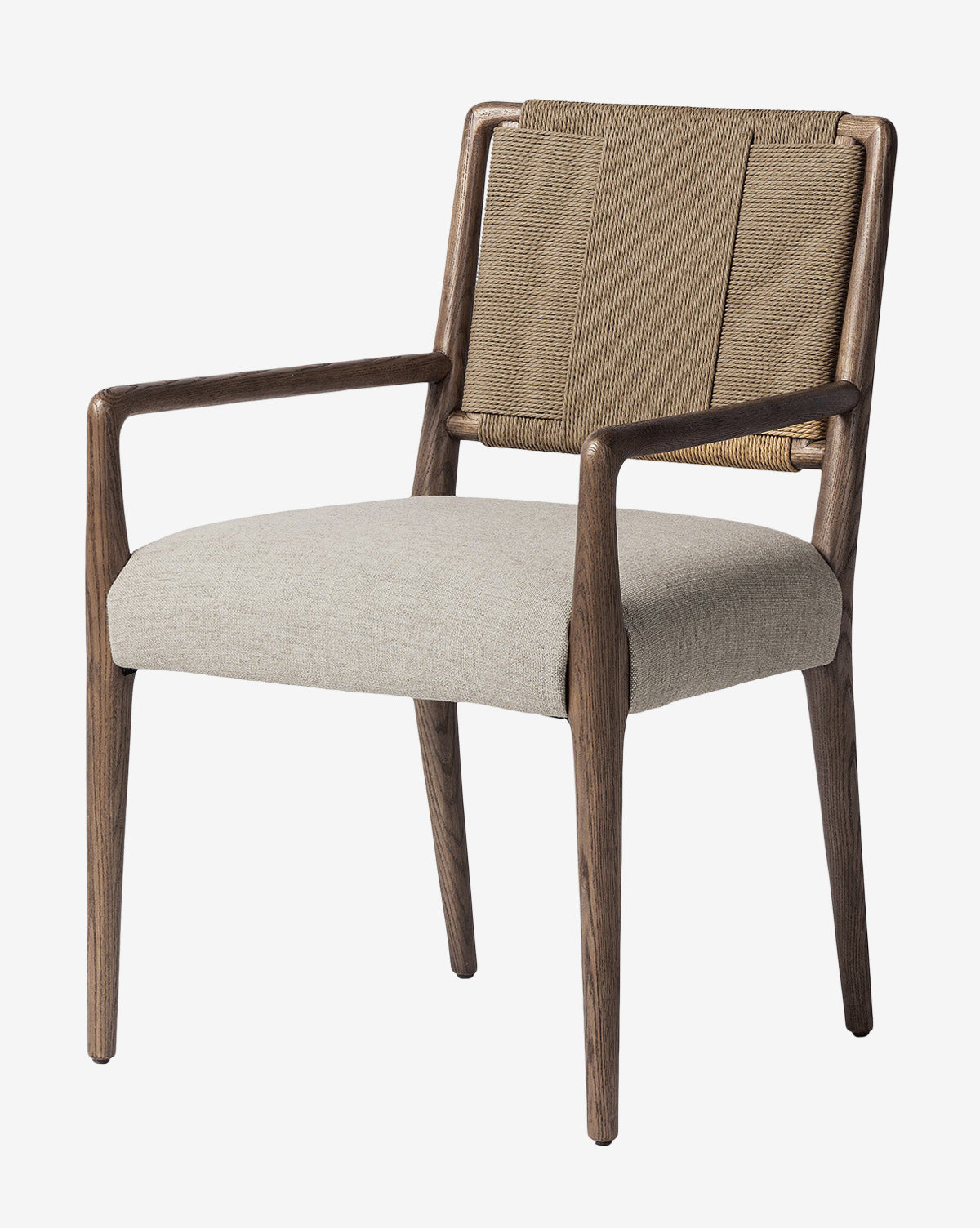 The Leola Dining Armchair features a modern oak frame, beige upholstered seat, rush back, angled legs, and curved armrests, shown against a plain white background by McGee & Co.