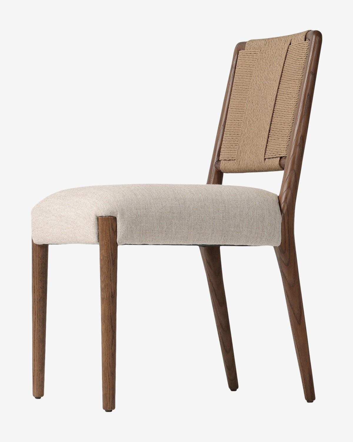 The Leola Dining Chair features a modern oak frame, beige upholstered seat, and rush back with clean lines and angled legs, shown against a white background by McGee & Co.