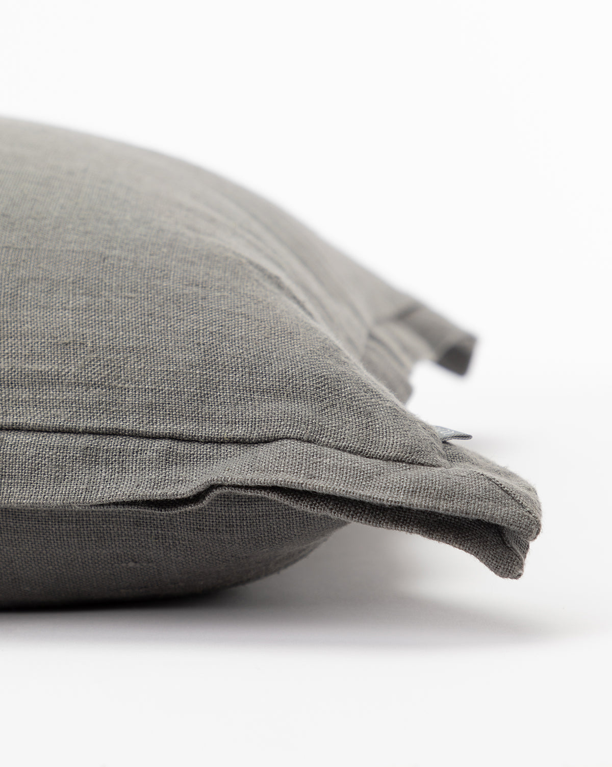 Close-up side view of the Liam Double Flange Pillow Cover in gray textured linen, featuring a visible edge seam, set against a plain white background, by McGee & Co.