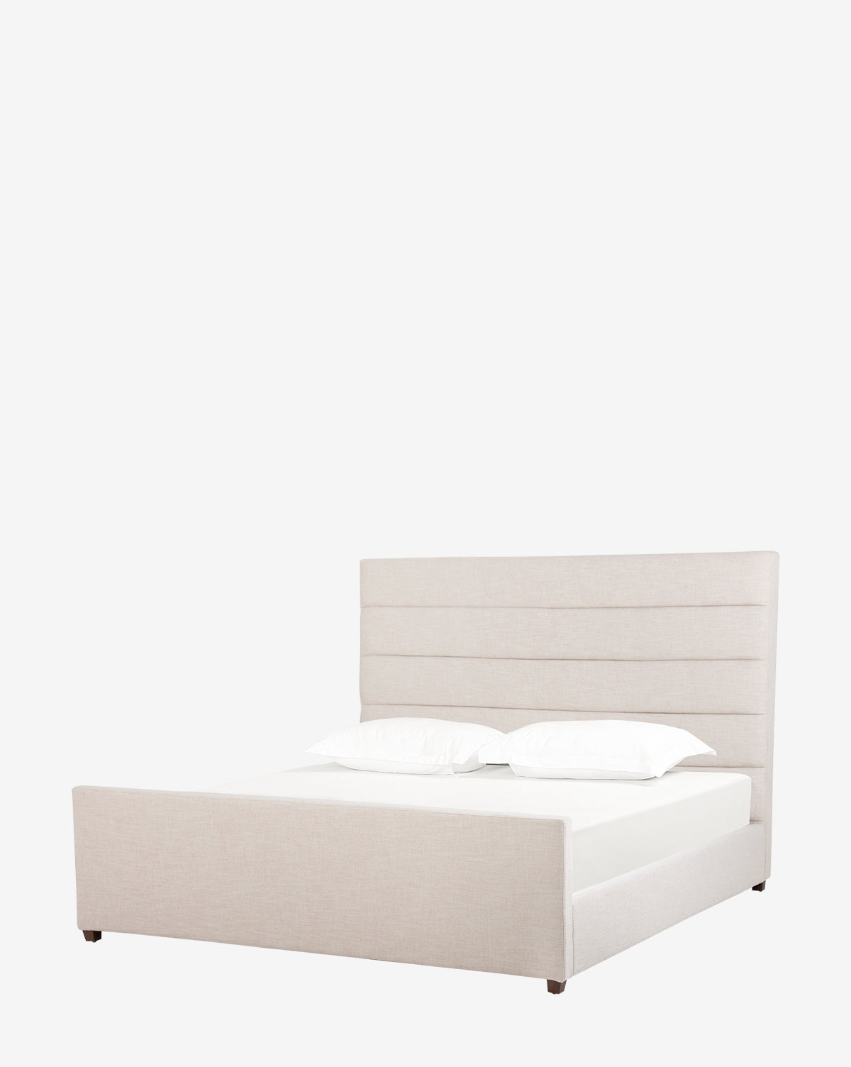 The Lila Bed showcases a modern silhouette with a tall, horizontal-panel headboard and low footboard in light beige fabric. Its quilted frame, minimalist design, and two crisp white pillows add to its contemporary appeal.