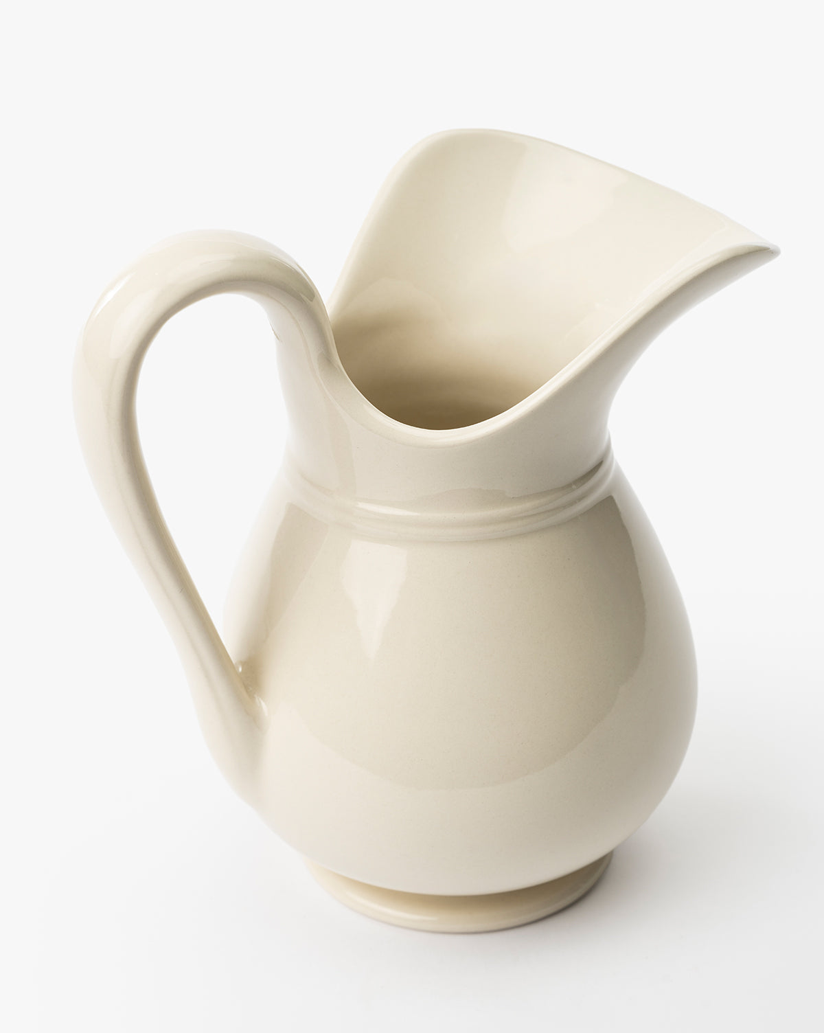 The Lumen Pitcher is a cream-colored stoneware piece featuring a wide spout and a curved handle, displayed against a white background by McGee & Co.