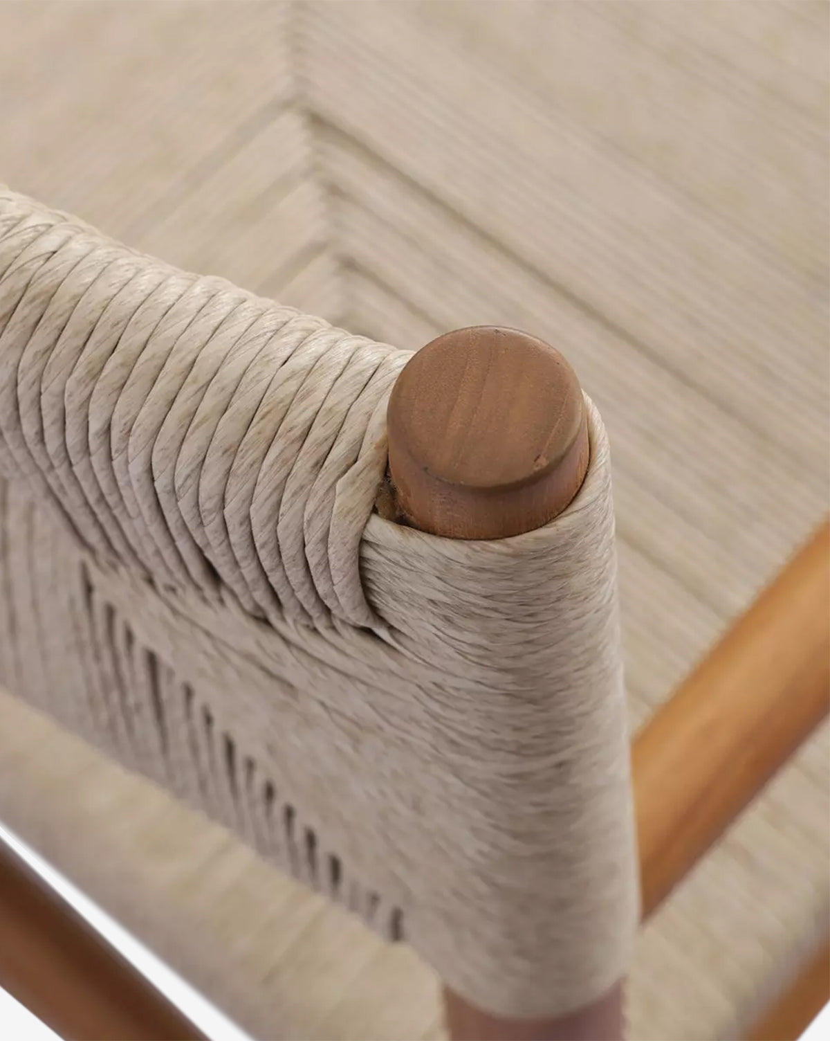 Close-up of the Lockridge Outdoor Chair showcases natural rope expertly woven around a rounded teak frame, emphasizing the textured, sturdy seat and backrest, by McGee & Co.