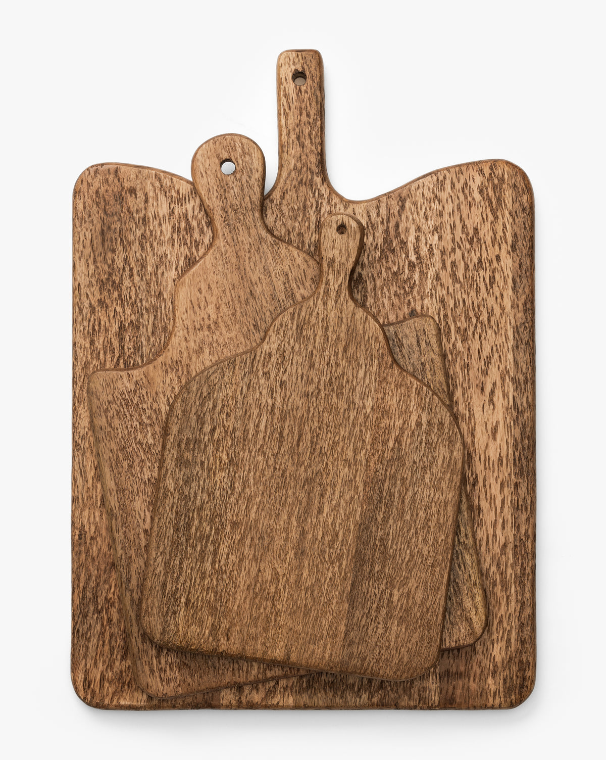 Three Longfellow Breadboards, each crafted from mango wood with a handle and unique grain, are stacked together against a plain white background—ideal for serving or adding rustic charm to your kitchen decor, by McGee & Co.