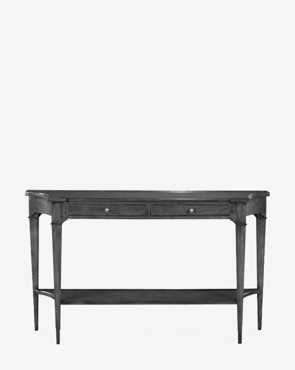 The Loren Console Table is crafted from acacia wood with a charcoal finish, featuring two small drawers, an open lower shelf, tapered legs, and simple knobs, set against a plain white background by McGee & Co.