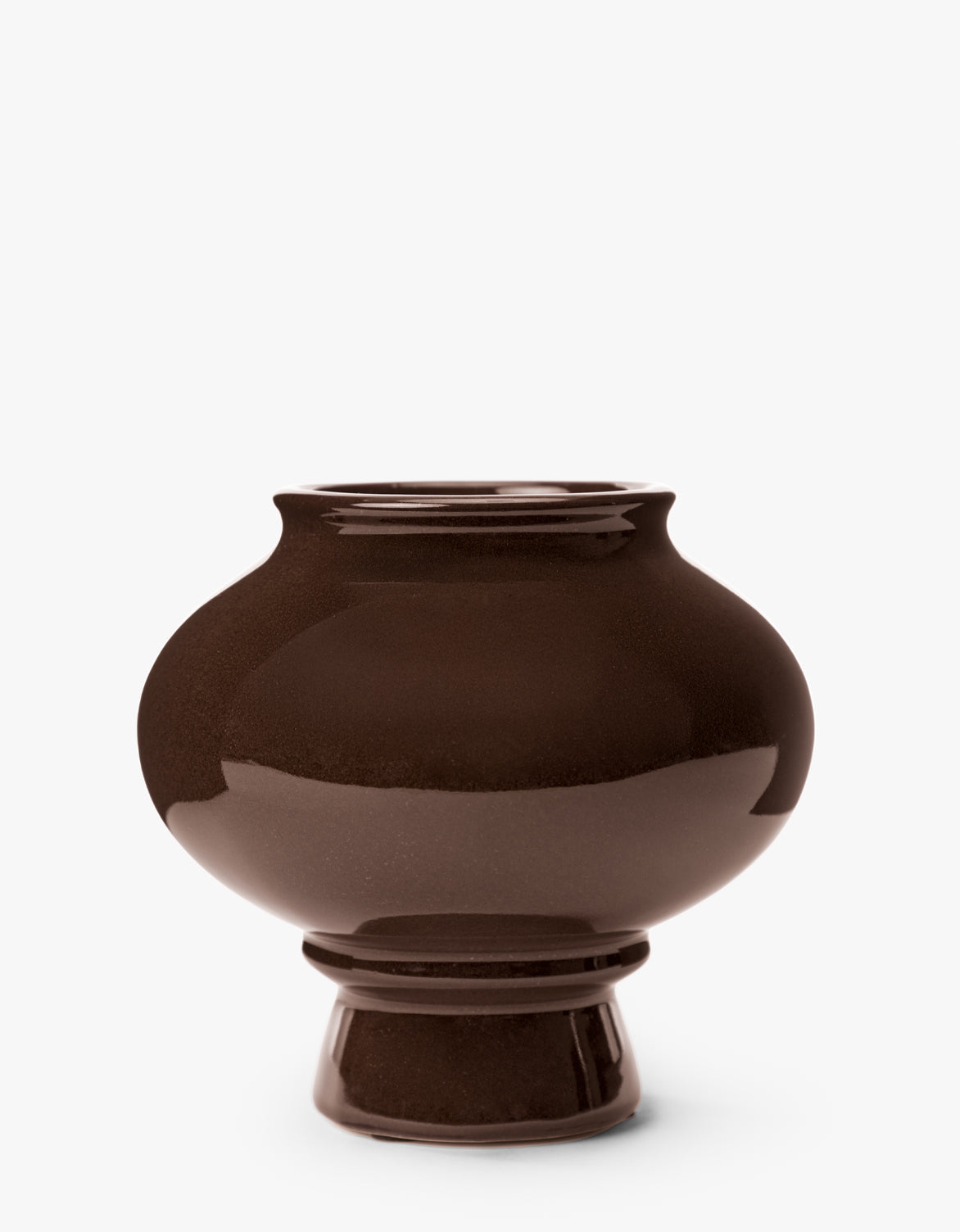 The Louis Vase is a modern, glossy dark brown ceramic sculptural vase with a wide rounded body and narrow raised base, shown against a plain white background—ideal for contemporary home decor, by McGee & Co.