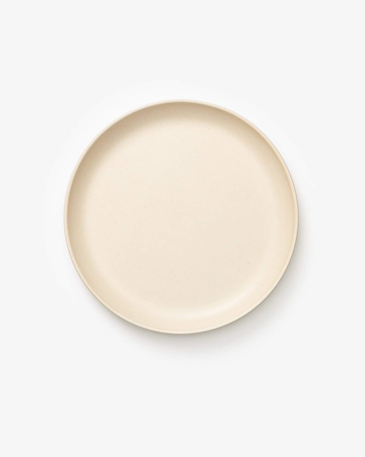 The Luana Side Plate is a plain, round, beige plate made of glazed stoneware—perfect for daily use and suitable for any setting, by McGee & Co.