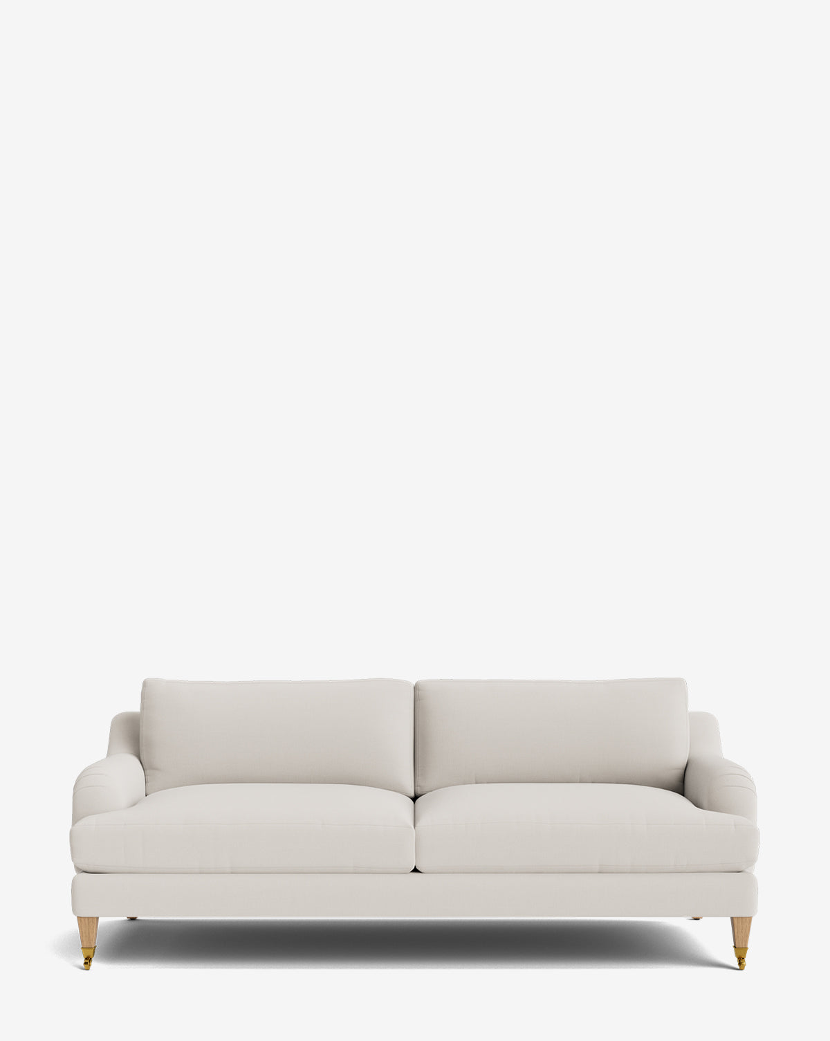 The Lucille English Roll Arm Sofa 78 is a modern, light beige sofa with two seat and back plush down-wrapped cushions, rounded arms, wooden legs with brass castors, and customizable options shown against a plain white background by McGee & Co.