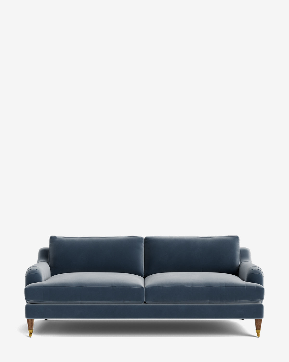 The Lucille English Roll Arm Sofa 78 features deep blue velvet upholstery, down-wrapped cushions, and wooden legs with brass castor wheels, shown against a plain white background by McGee & Co.