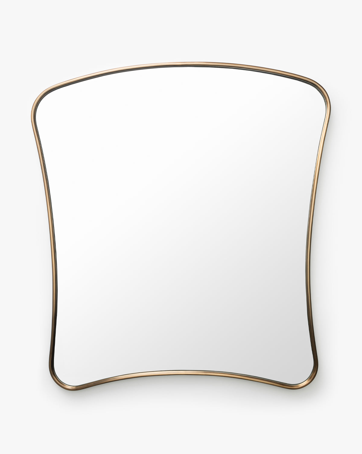 The Ludwig Wall Mirror, featuring a large curved rectangular design and a thin brass-finished metal frame, stands against a plain white background by McGee & Co.