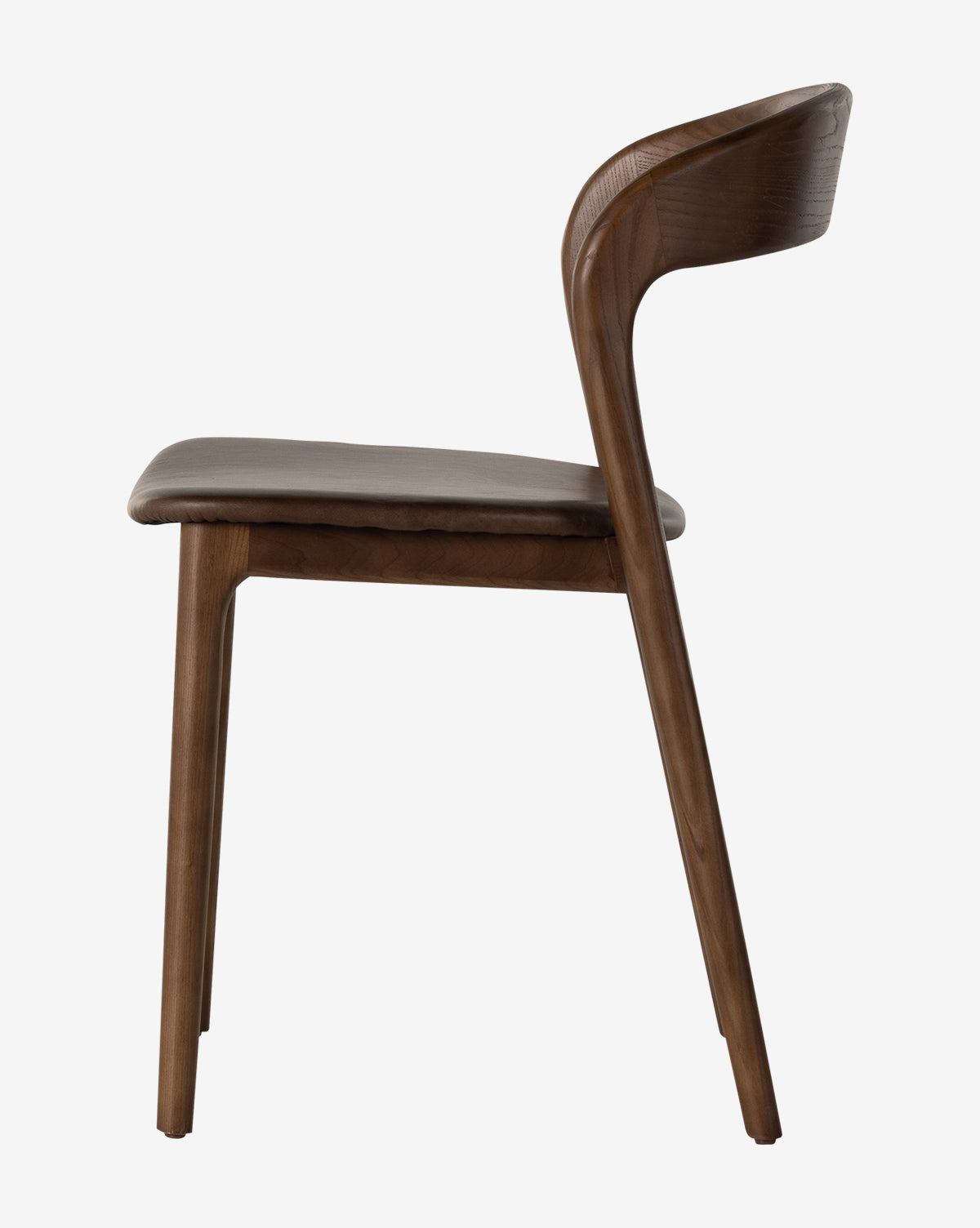 Side view of the Lucinda Dining Chair showcasing a curved backrest and cushioned top grain leather seat, with smooth minimalist lines and a rich brown finish inspired by Scandinavian design, by McGee & Co.
