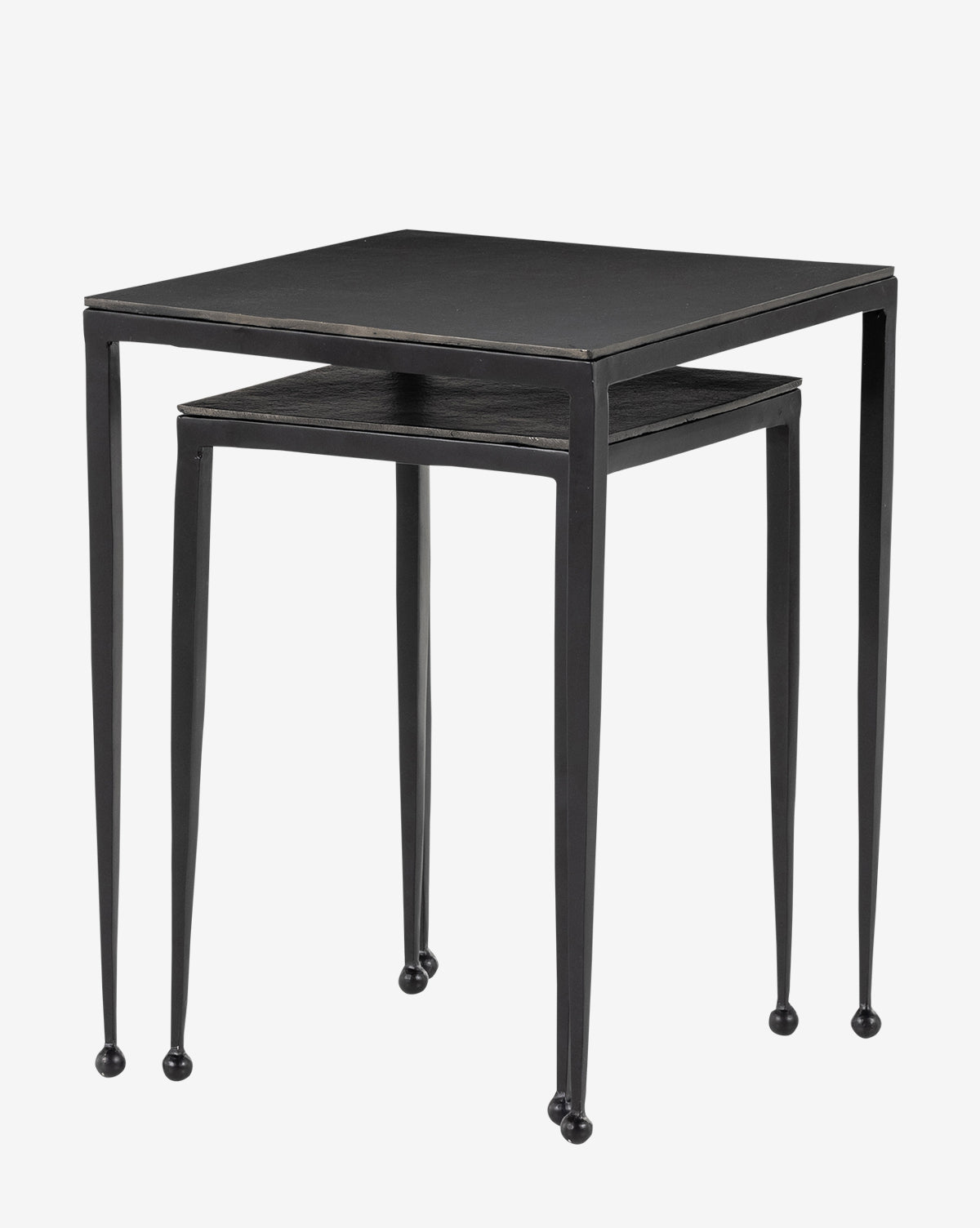 The Biddy Nesting End Tables feature two minimalist black tables with square tops and slender, wire-brushed, slightly tapered legs. The smaller table fits neatly under the larger one, both ending in small rounded feet for an elegant touch by McGee & Co.