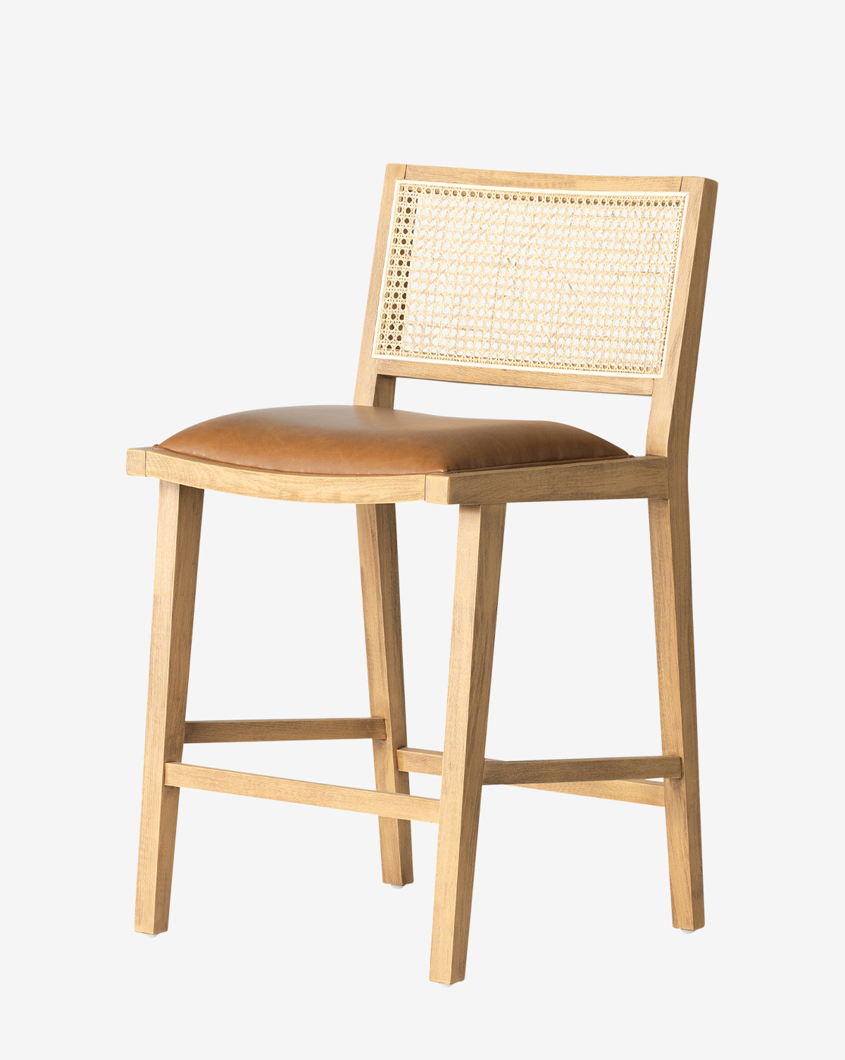 The Emeline Stool has a solid beech frame, tan faux leather cushion, and woven cane backrest, shown against a plain white background by McGee & Co.