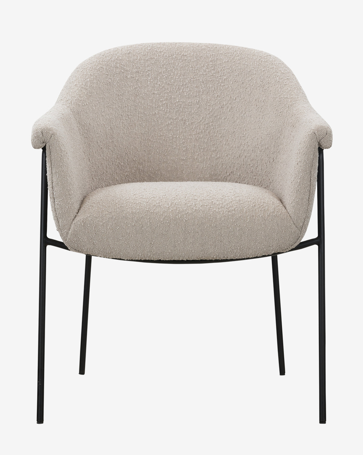 The Sabbath Dining Chair is a modern, light beige upholstered seat with a rounded back, curved arms, and slender black metal legs, shown from the front against a plain white background by McGee & Co.