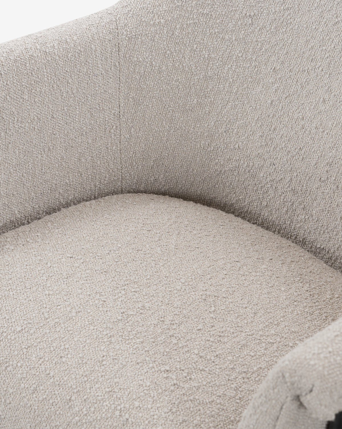 Close-up of the Sabbath Dining Chair, featuring a light beige, soft performance fabric with cushioned seat, rounded armrests, and backrest—an inviting accent for any room, by McGee & Co.