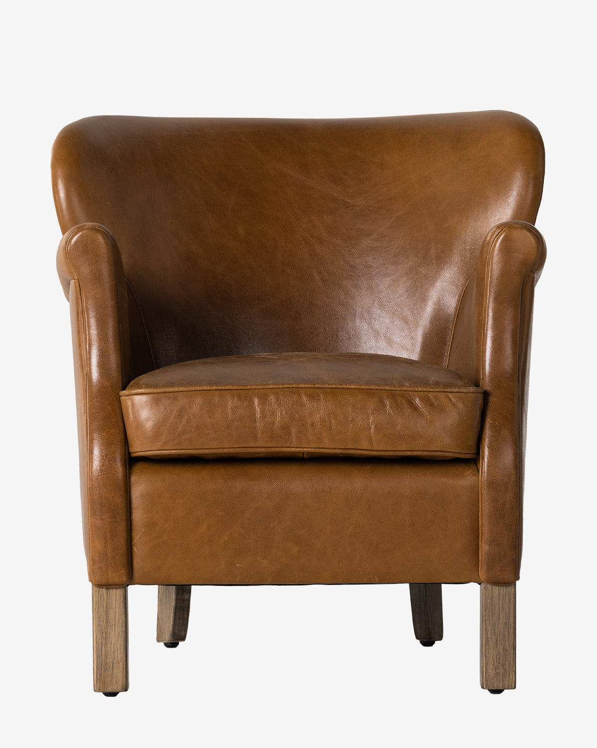 The Jarah Lounge Chair, featuring brown top-grain leather, rounded arms and backrest, wooden legs, and a smooth minimalist design, is shown against a plain white background by McGee & Co.