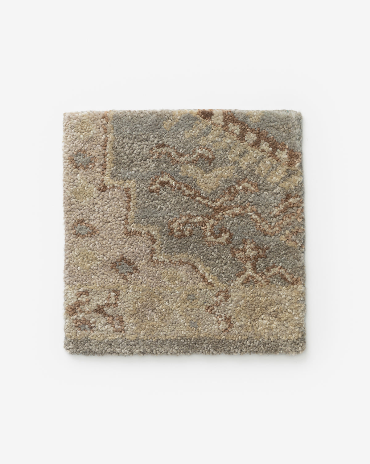 The Lazio Rug Swatch features a textured, abstract pattern in beige, tan, and gray—making it the perfect handmade accent to subtly enhance any living room, by McGee & Co.