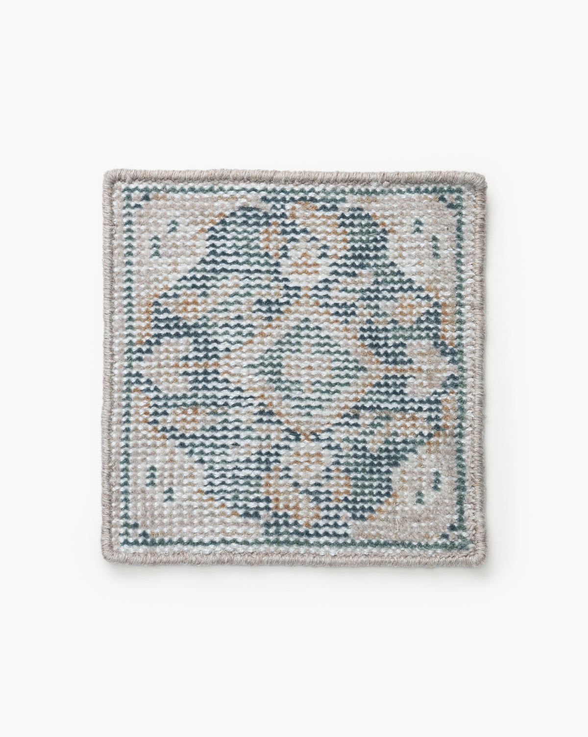 The Merilyn Hand-Knotted Rug Swatch is a square coaster with a geometric diamond and dot pattern in blue, beige, and gray, finished with a light border for a stylish neutral look, by McGee & Co.