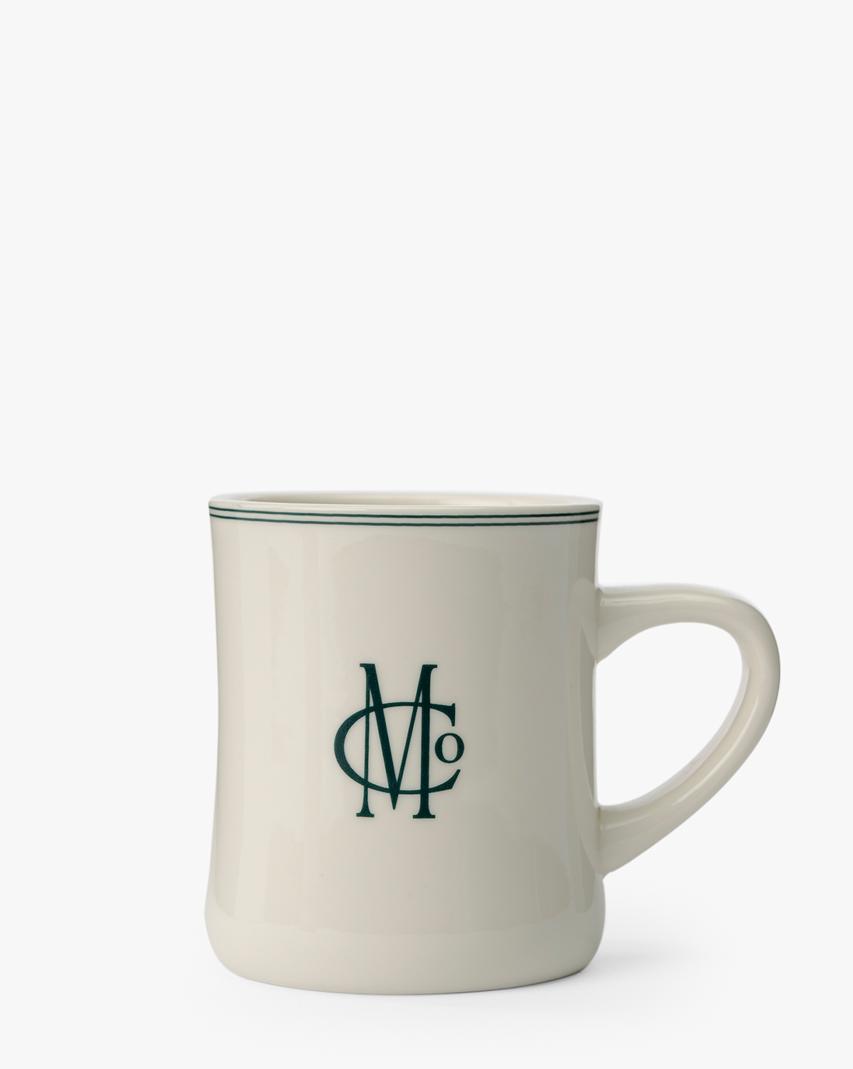 The M&Co Diner Mug is a white ceramic mug with a green rim and a stylish green "M O" monogram on the front, shown against a plain white background, by McGee & Co.