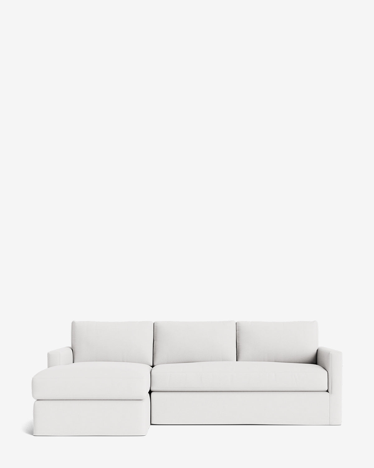 The Macy Slipcover Chaise Sectional 101 is a modern, minimalist white sofa with clean lines and a deep design, featuring a left-side chaise lounge and set against a plain white background by McGee & Co.