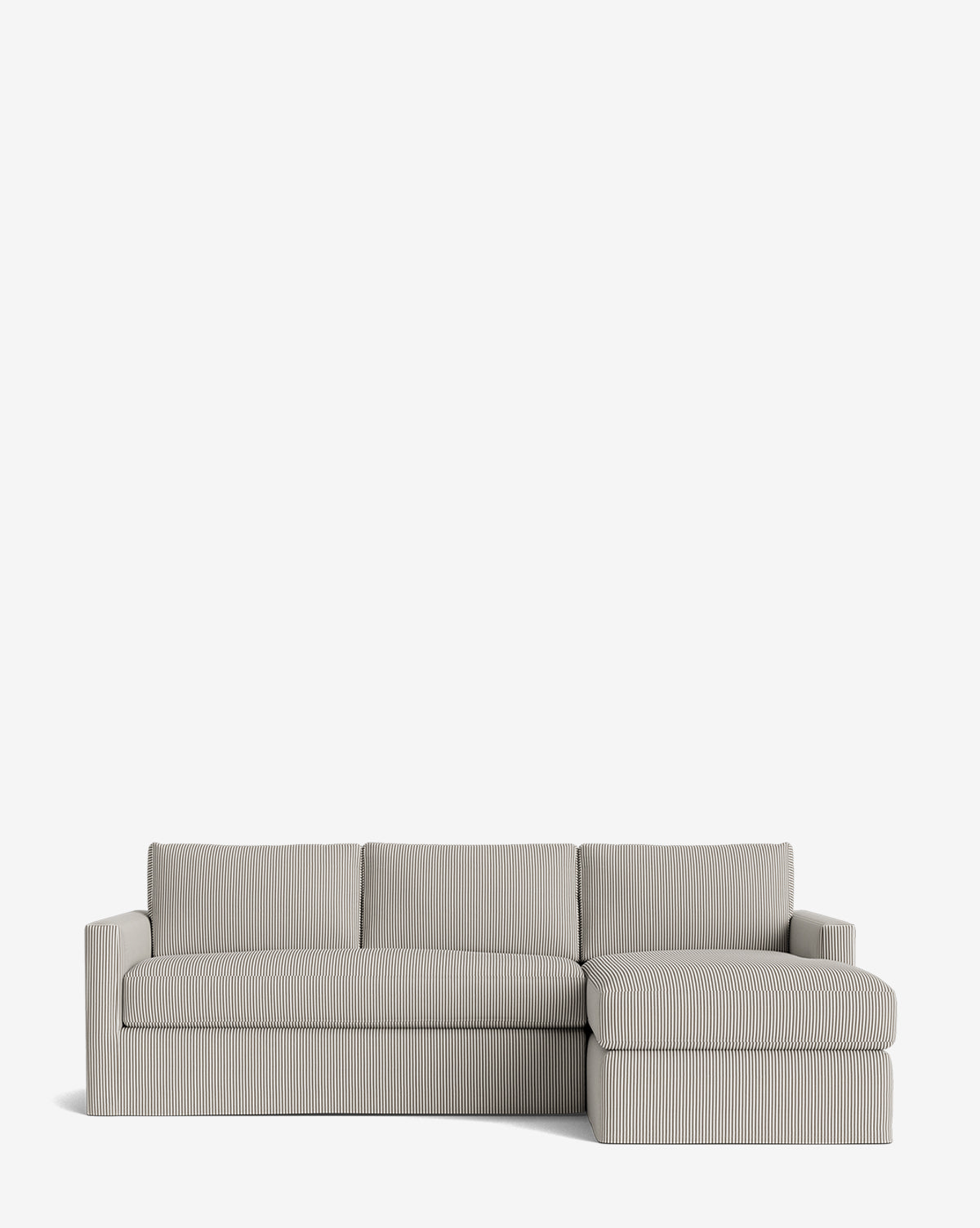 The Macy Slipcover Chaise Sectional 101 is a modern, light gray customizable sofa with subtle vertical stripes, three seat cushions, and a right-facing chaise lounge, shown against a plain white background by McGee & Co.