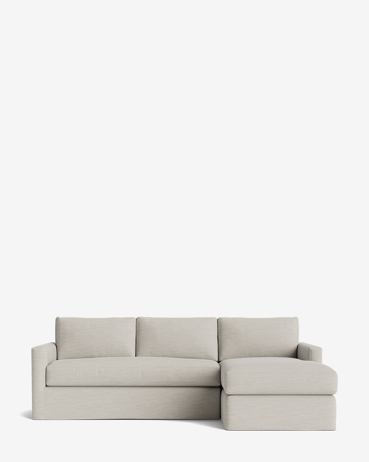 The Macy Slipcover Chaise Sectional 101 is a modern, light beige sofa with clean lines, three seat and back cushions, low square arms, and a right-side chaise lounge set against a plain white background by McGee & Co.