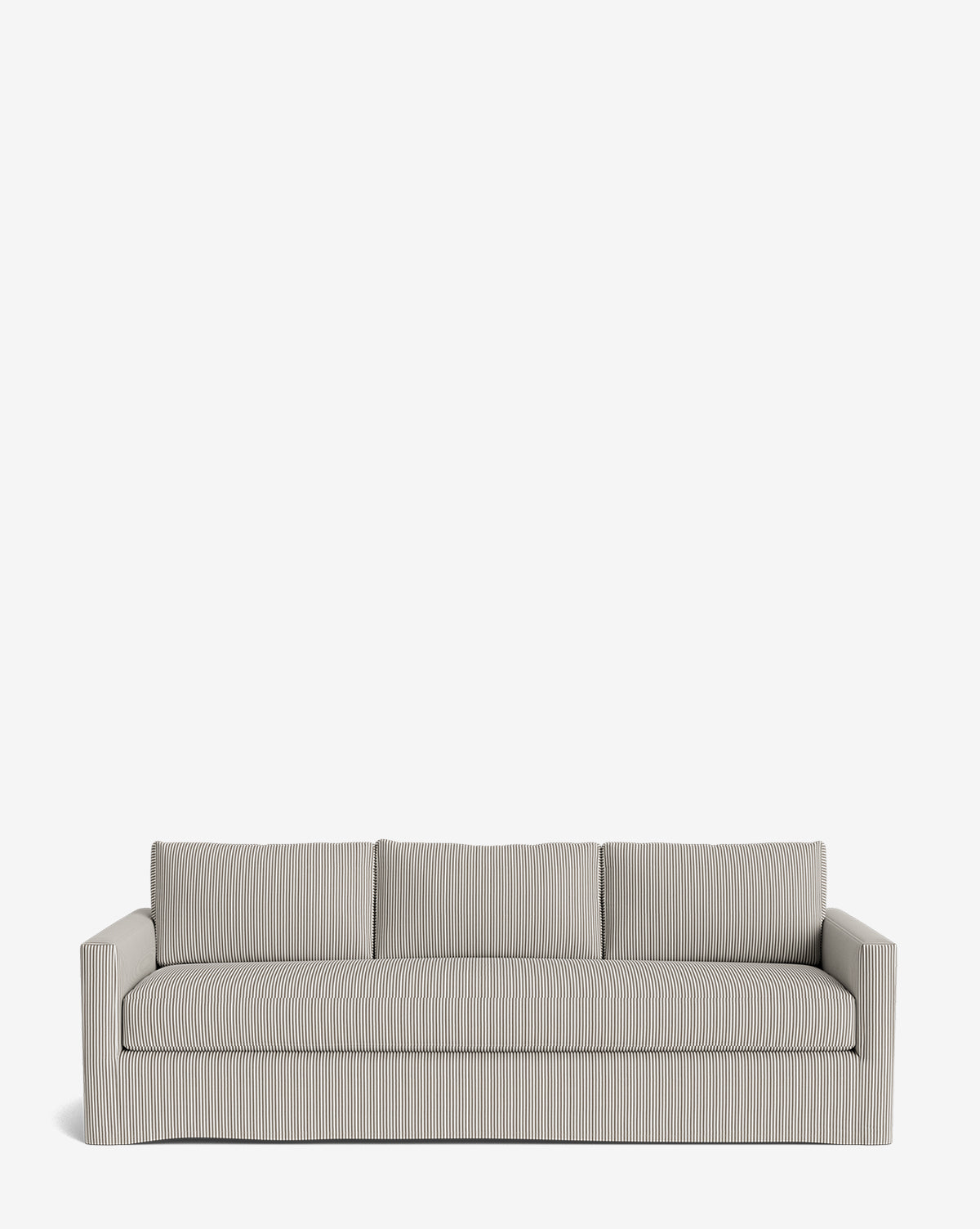 The Macy Slipcover Sofa (84-96) is a light gray customizable sofa with subtle vertical stripes, square arms, and three back cushions, offering flexible three-person seating against a plain white background by McGee & Co.