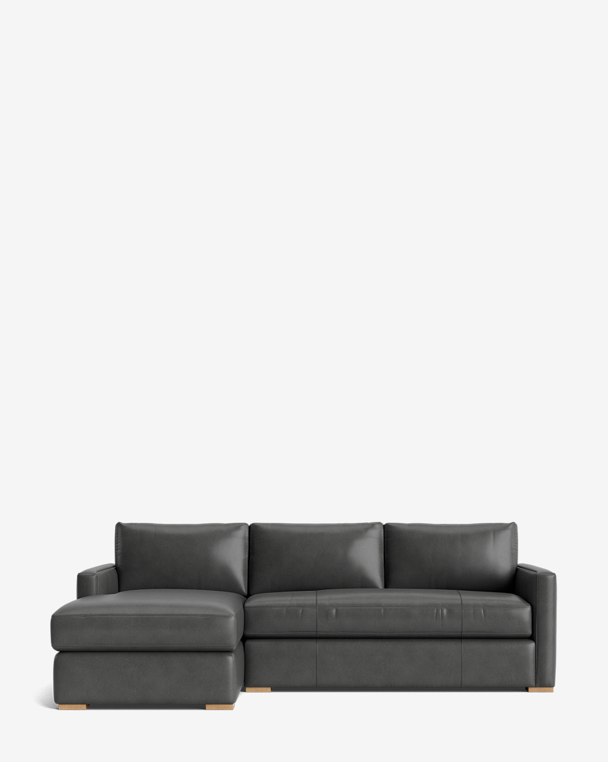 The Macy Upholstered Chaise Sectional 101 is a modern dark gray sofa with a left-side chaise, three seat and back cushions, and light wood feet, shown on a plain white background by McGee & Co.