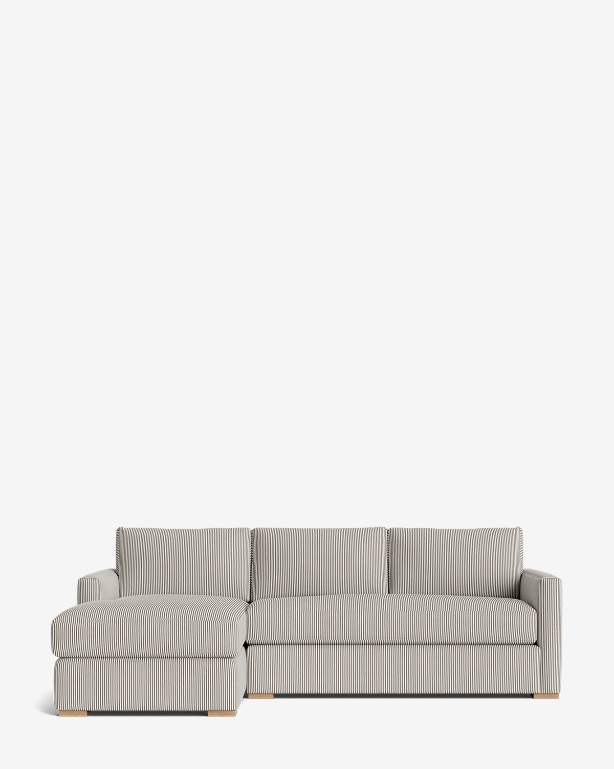 The Macy Upholstered Chaise Sectional 101 features light gray fabric with subtle vertical stripes, wooden block feet, a left-facing chaise, and three seat cushions—perfect for a modern living room, by McGee & Co.
