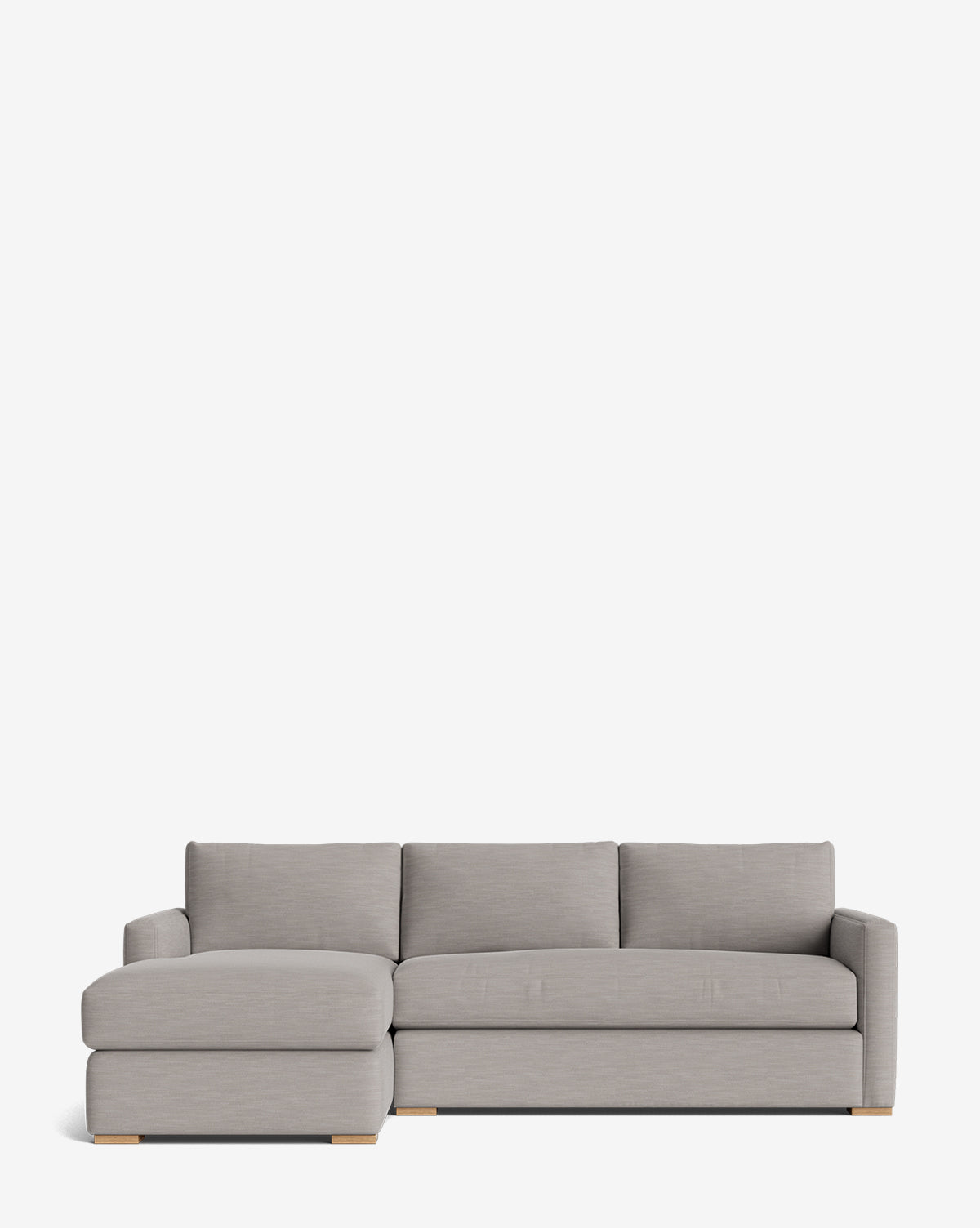 The Macy Upholstered Chaise Sectional 101 features a modern, light gray design with a left-side lounge, three seat and back cushions, low wooden legs, and minimalist style—perfect for customizing any living room, by McGee & Co.