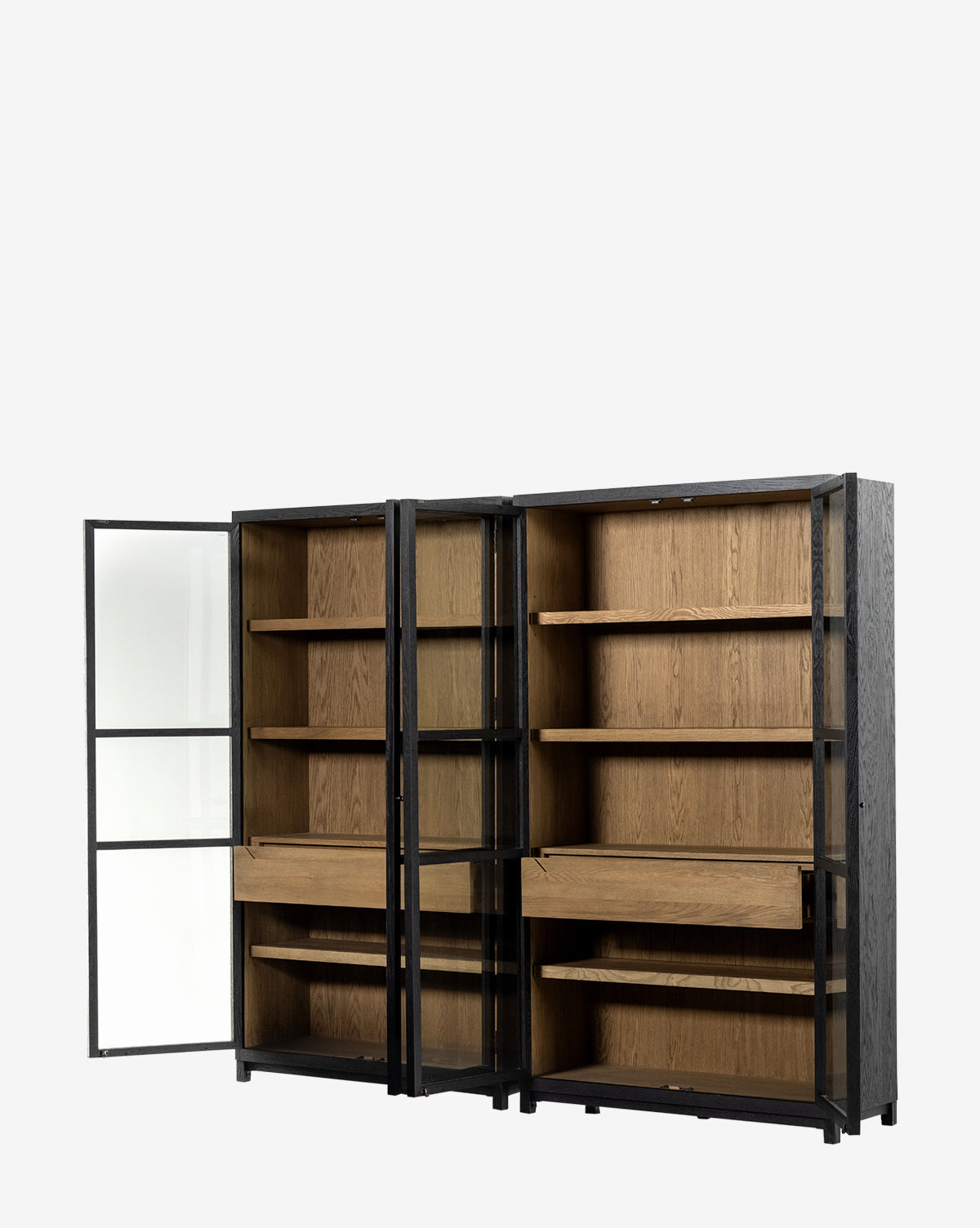 The Maddox Bookcase features a black metal frame, glass doors, and wooden shelves with two drawers. Shown empty against a white background, one door is open to reveal the interior storage options by McGee & Co.