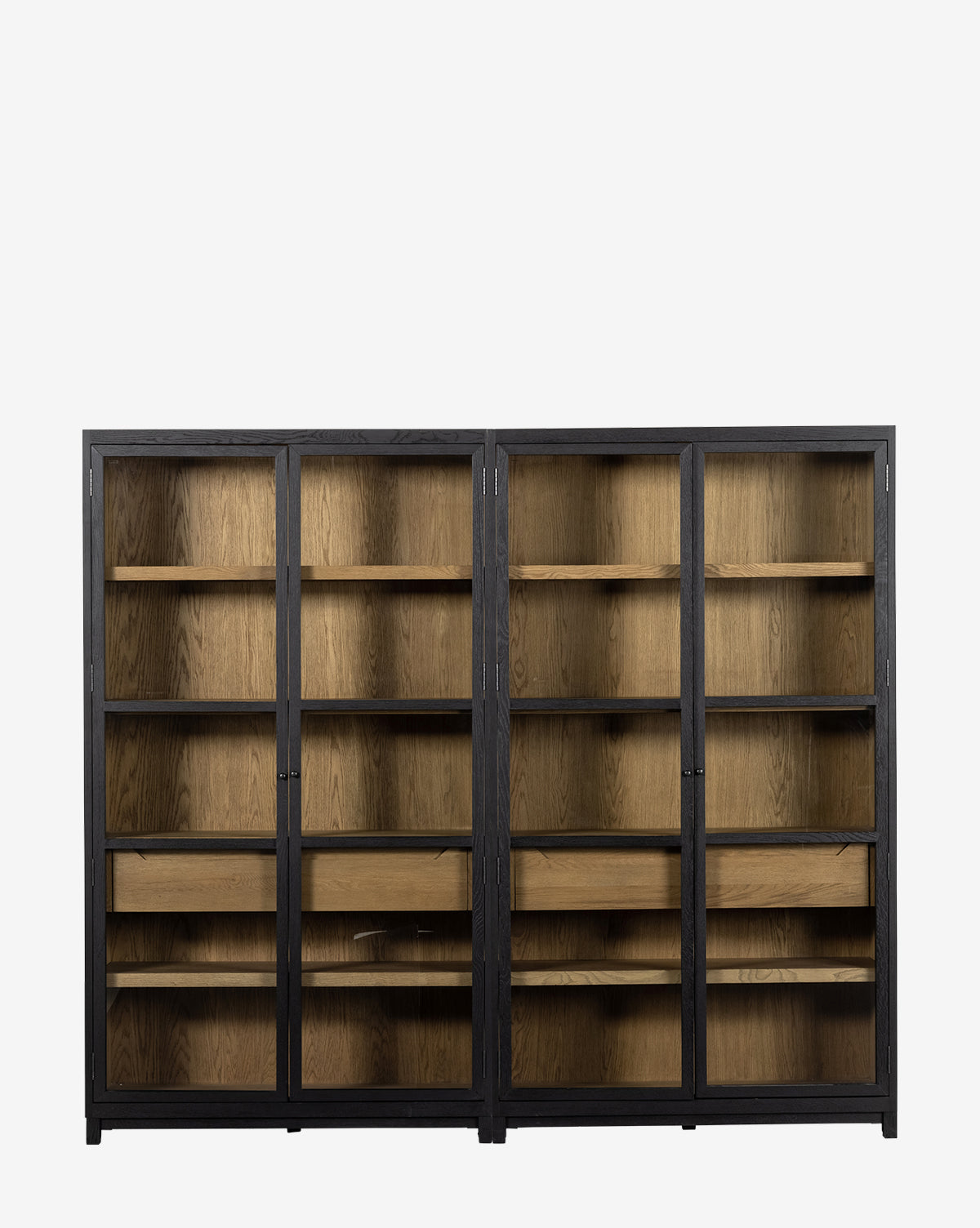 Two tall Maddox Bookcase cabinets with black frames and glass doors, each offering five shelves and a central wooden drawer. Both cabinets are empty, highlighting the natural wood grain on shelves and drawers by McGee & Co.