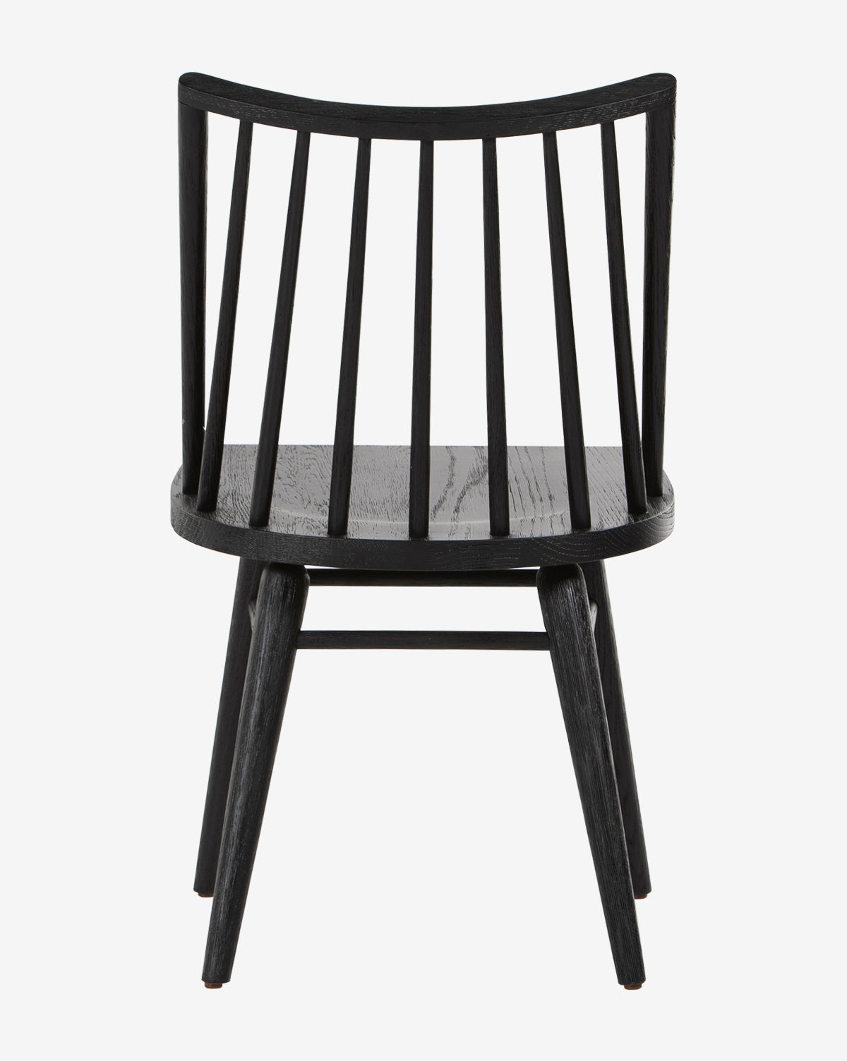 The Madison Dining Chair is black with a curved spindle backrest, four angled legs, and a flat seat, shown from the back on a plain white background by McGee & Co.